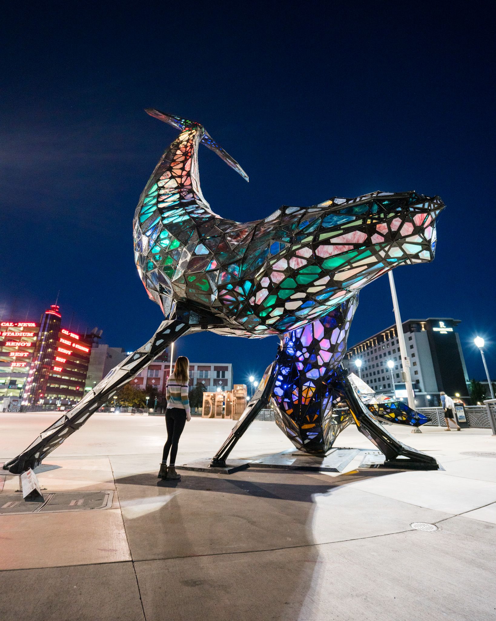 Woman looking at the space whale statue in downtown Reno