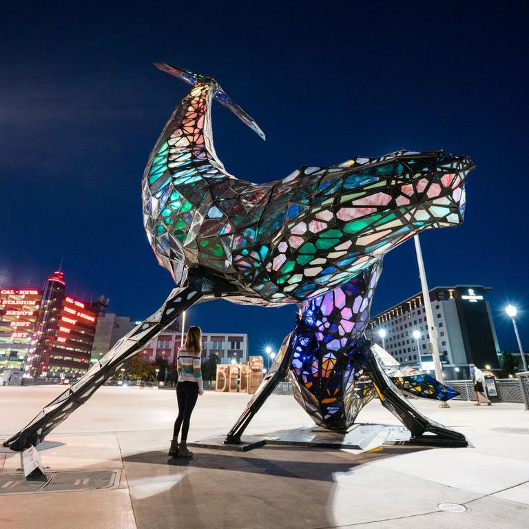 Woman looking at the space whale statue in downtown Reno