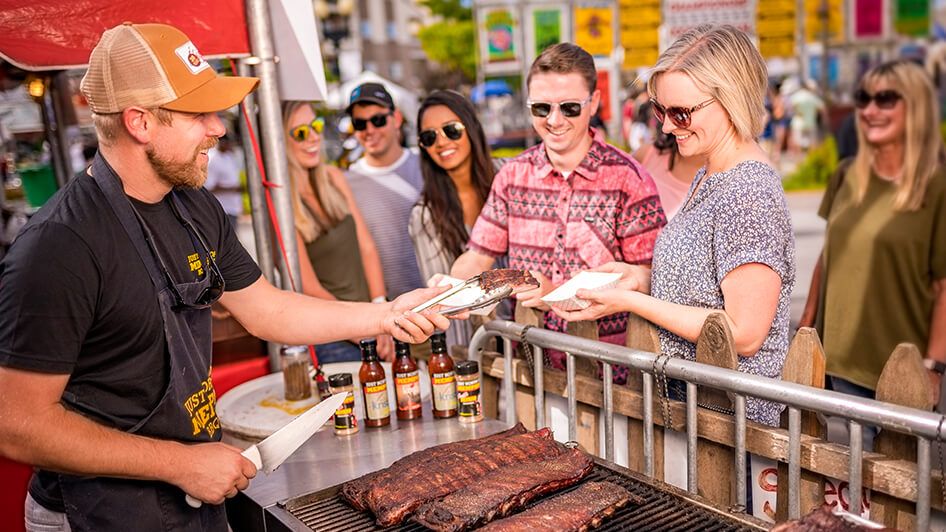 Woman purchasing ribs at the Nugget Rib Cook Off