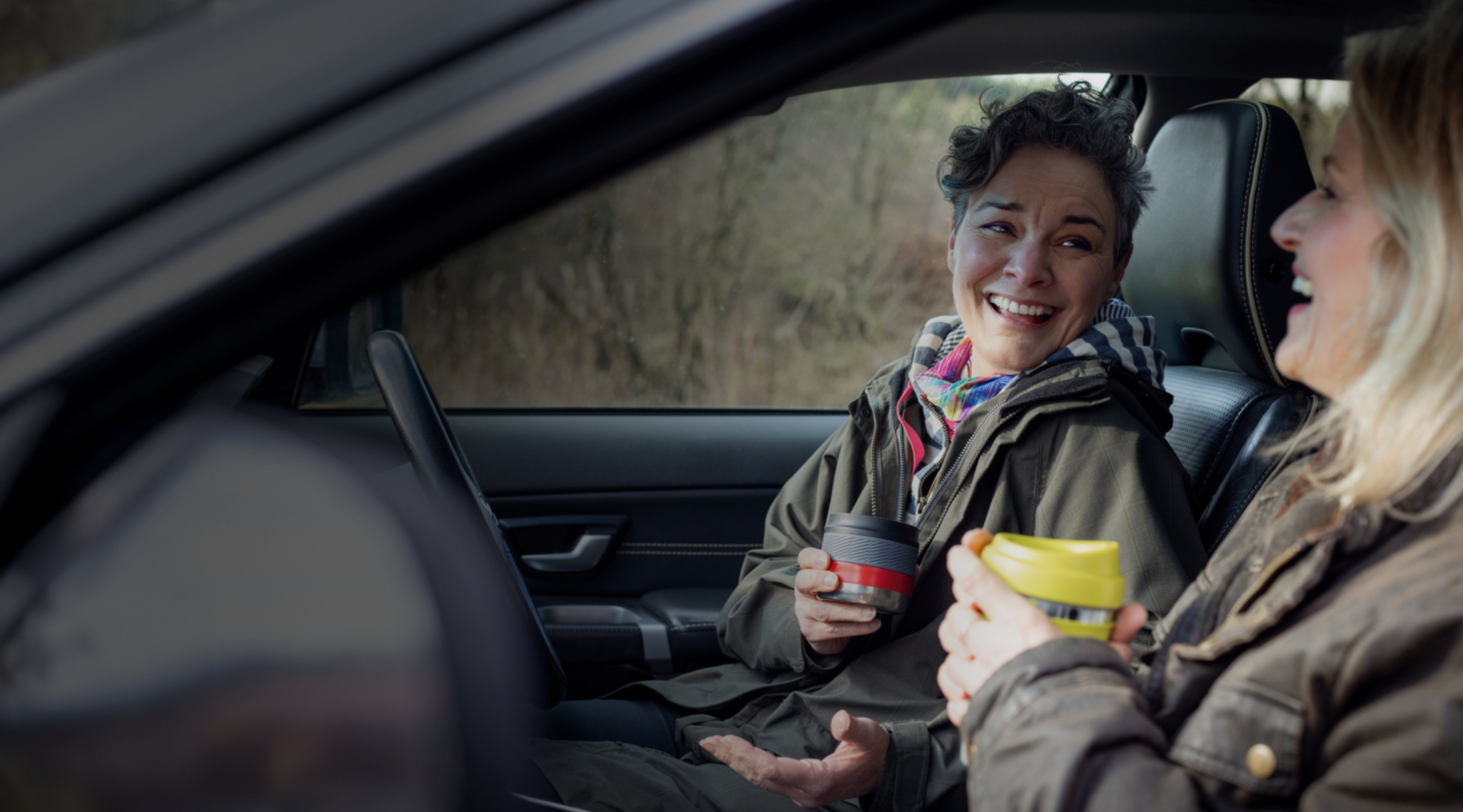 Zego driver checking sitting with her friend in her car on an adventure