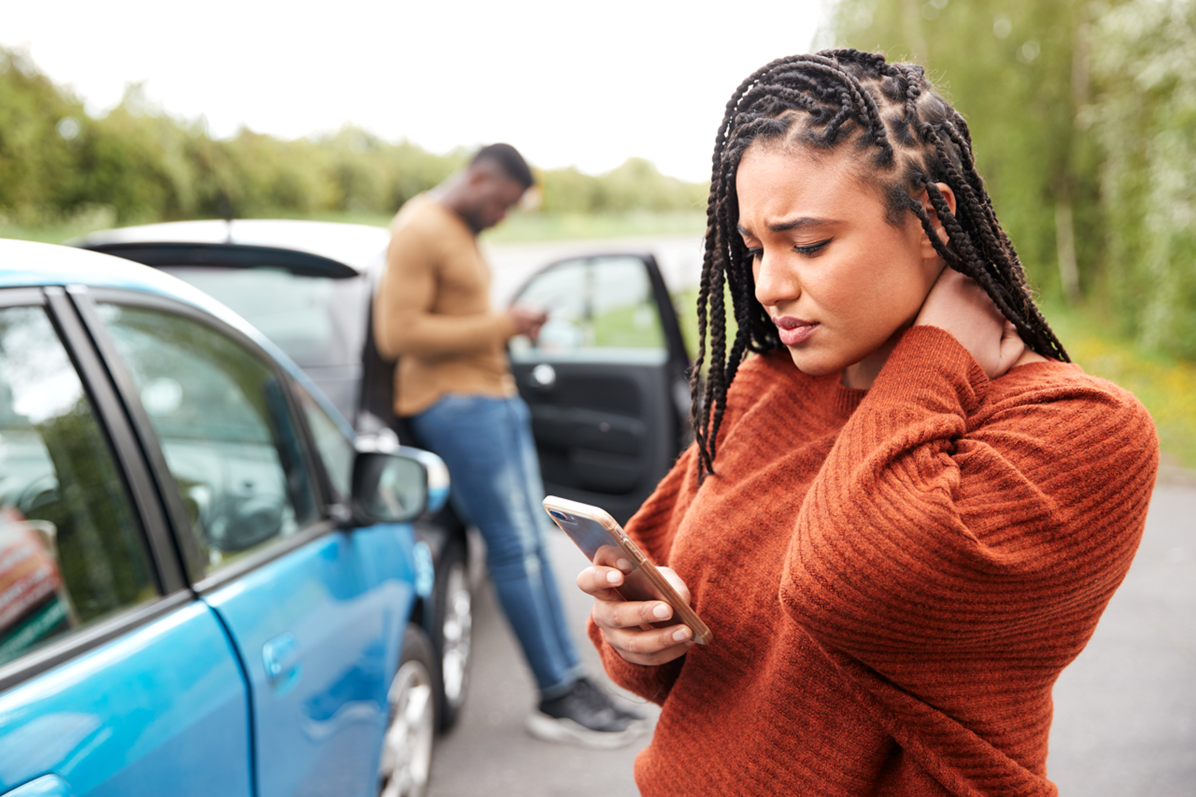 woman on phone on roadside after a minor accident
