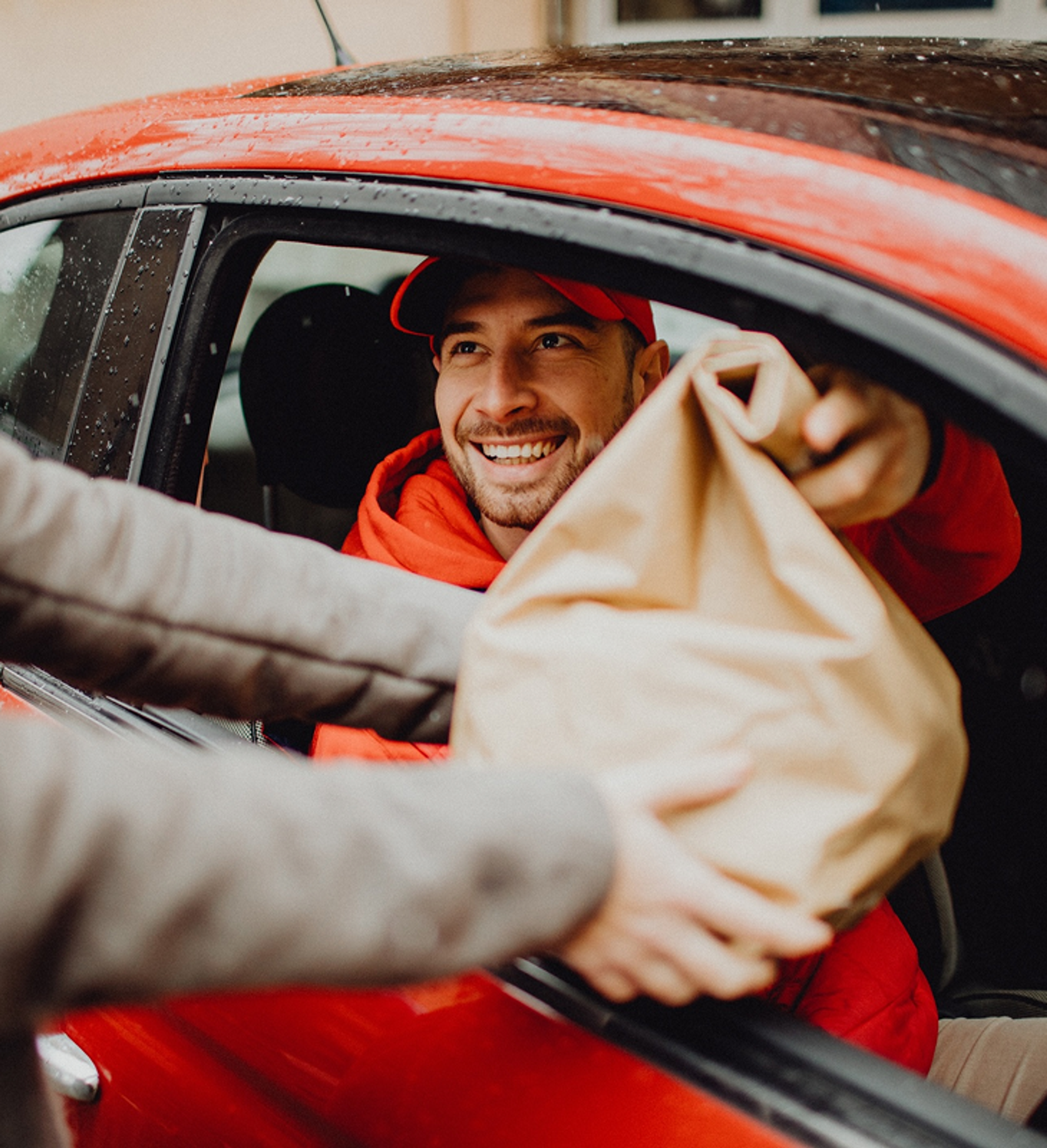 Zego car delivery driver handing over takeaway