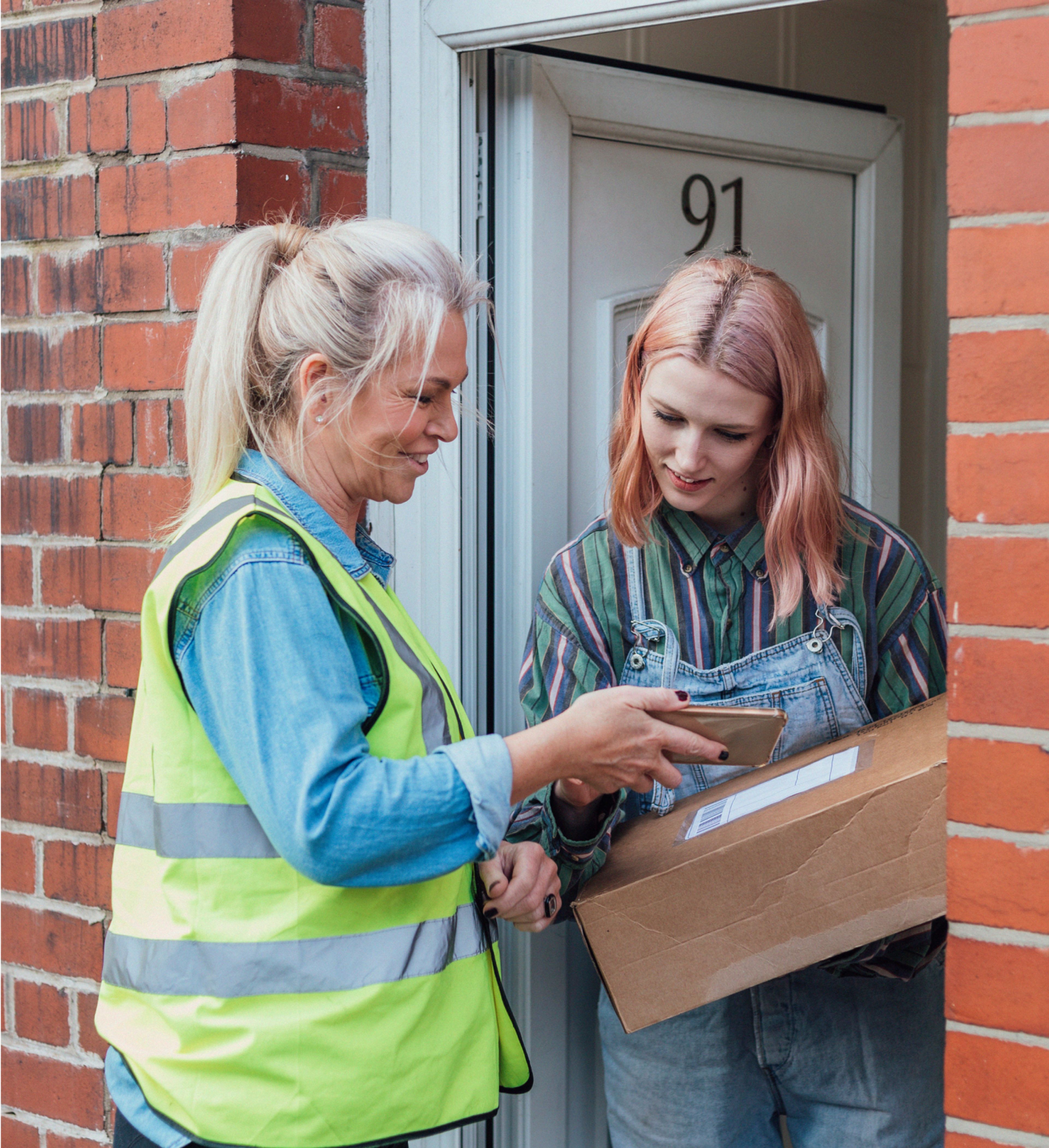 Zego car delivery driver handing a parcel over to a customer