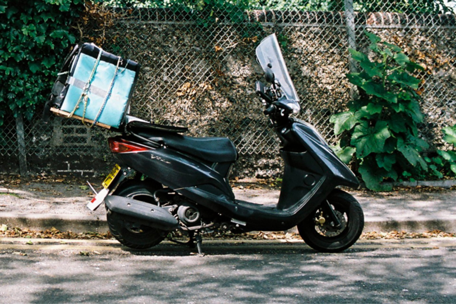 Photo of a delivery scooter parked on a road