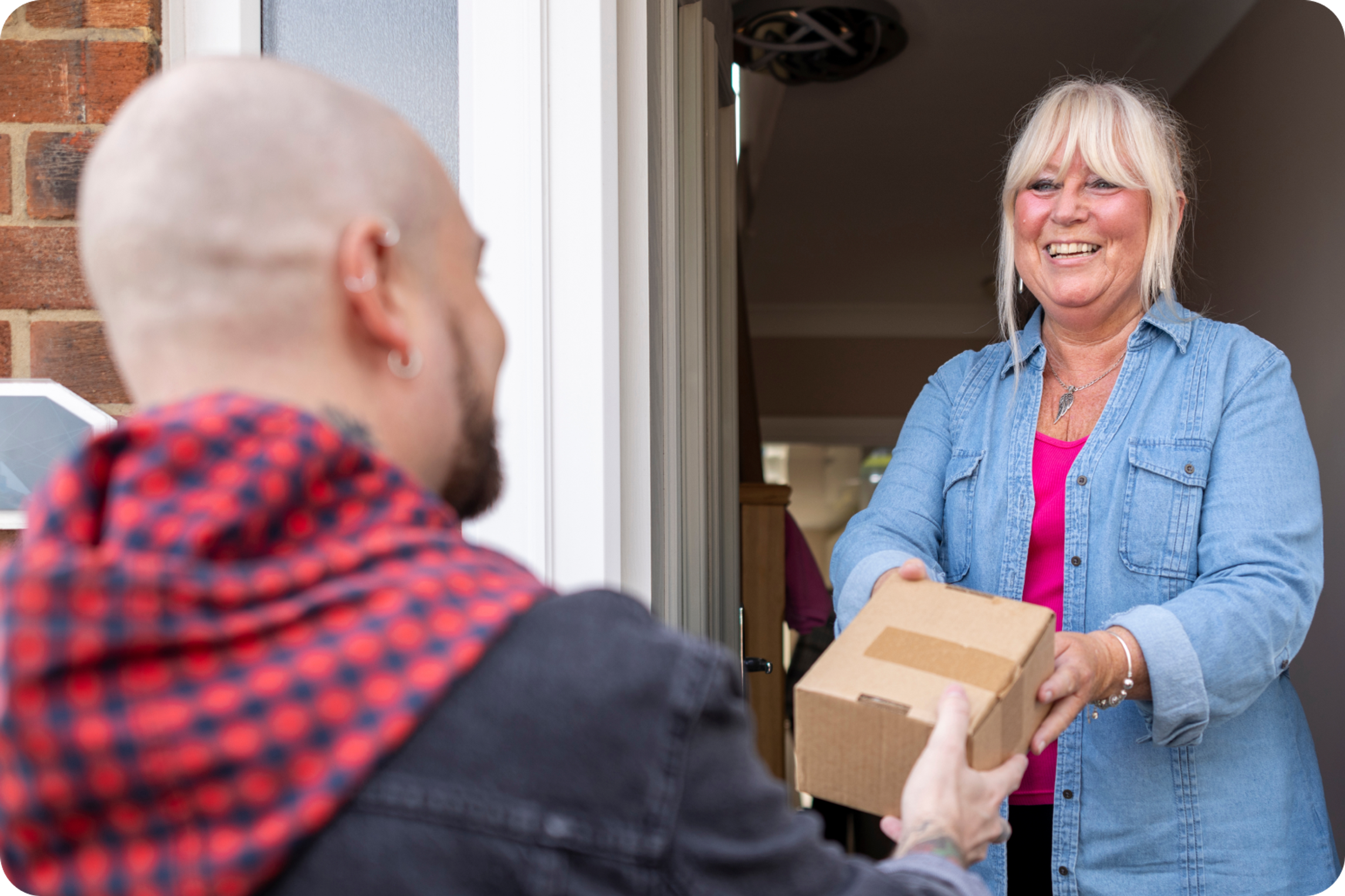 Zego car delivery driver handing a parcel over to a happy customer