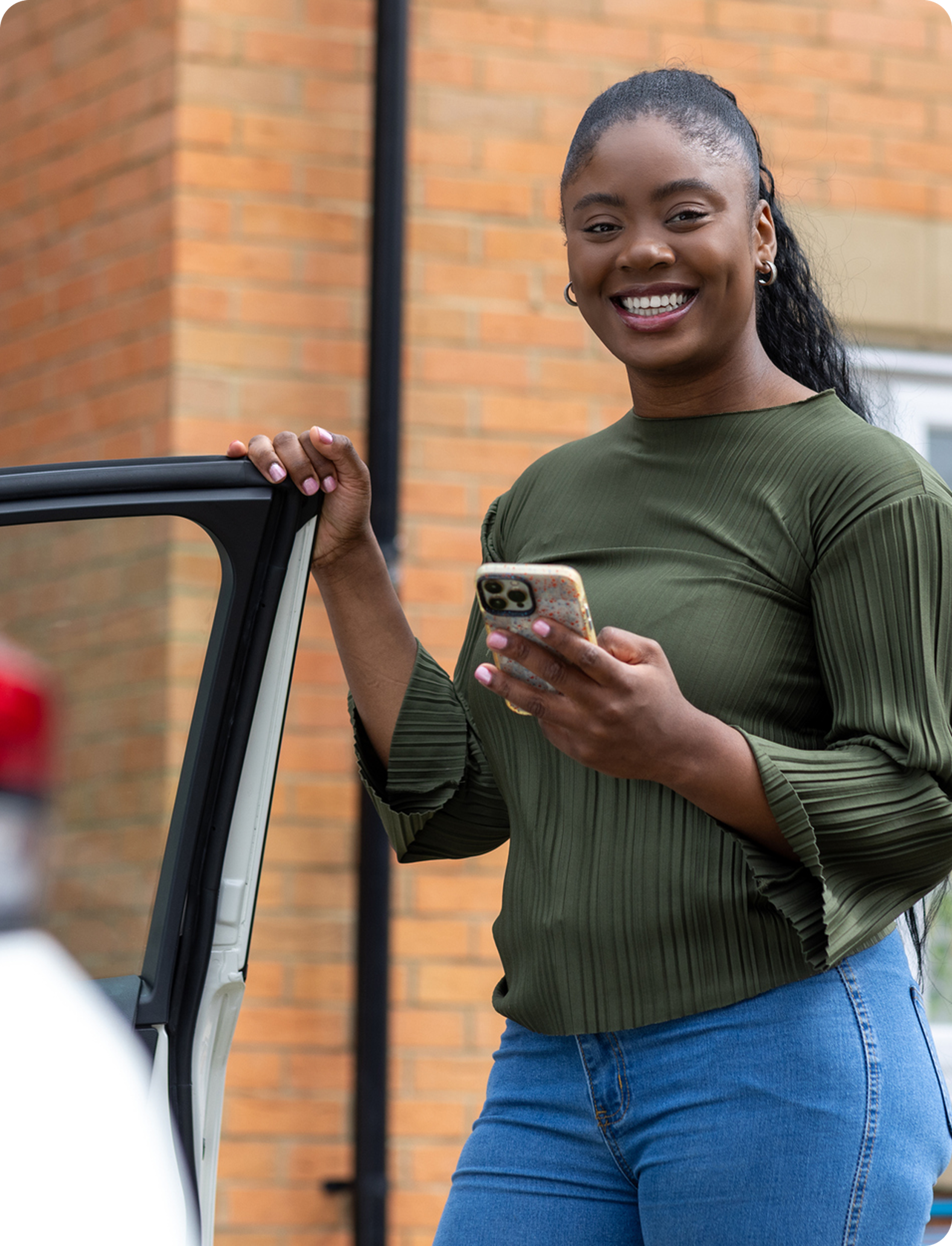 smiling learner driver getting into her car.