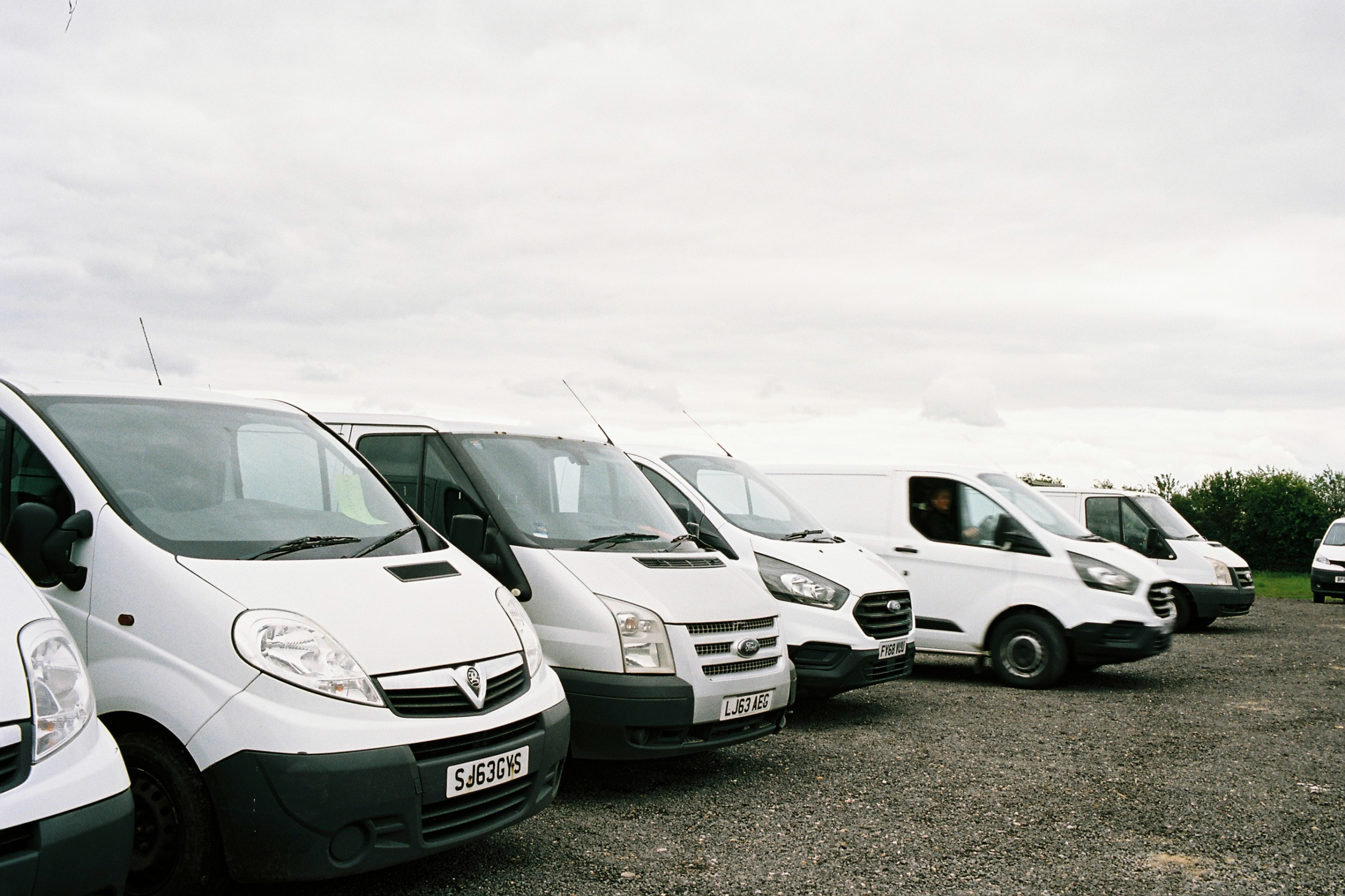 A parked row of panel vans