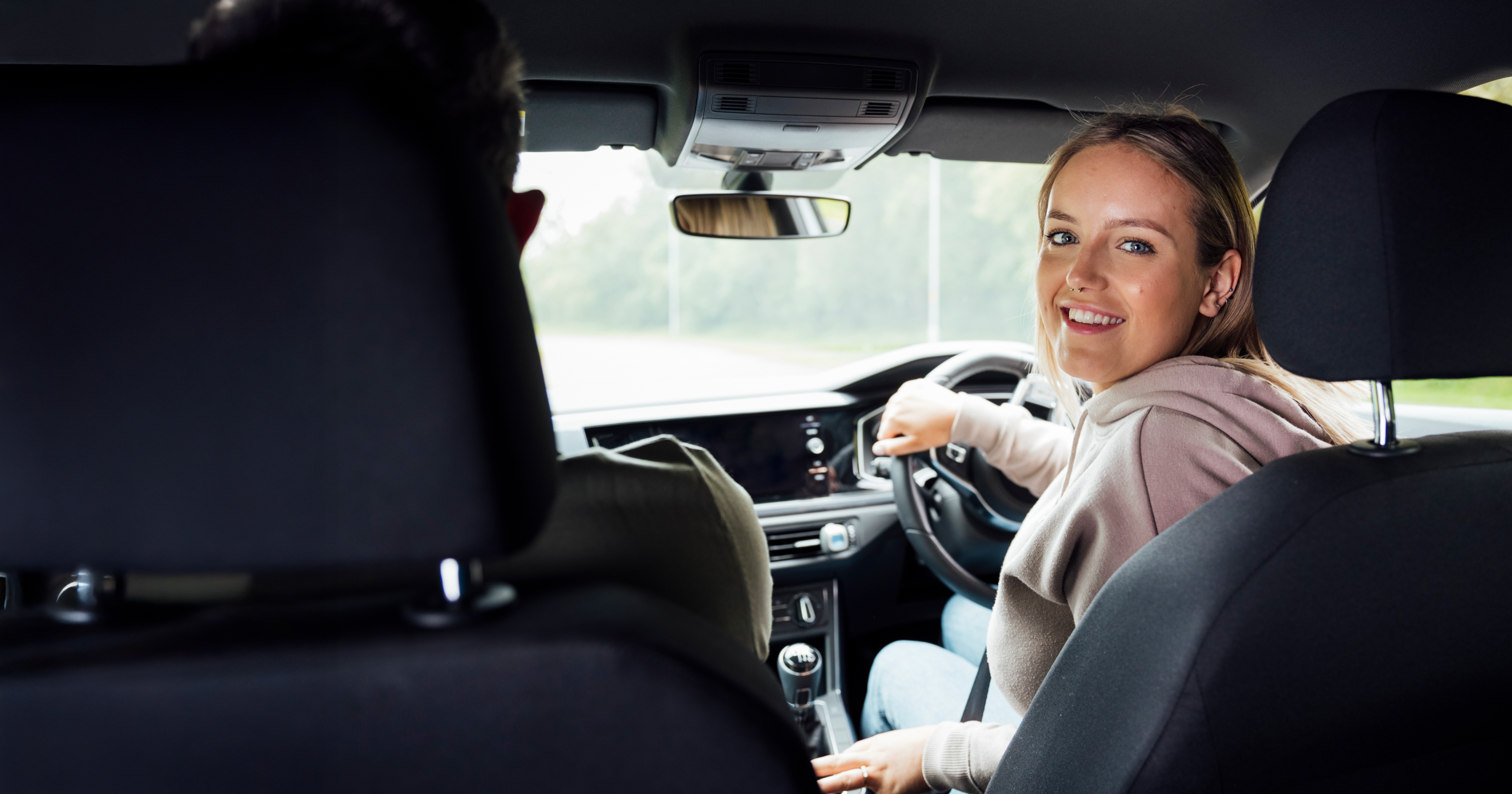 Smiling Zego driver sat in the driver seat of his car.