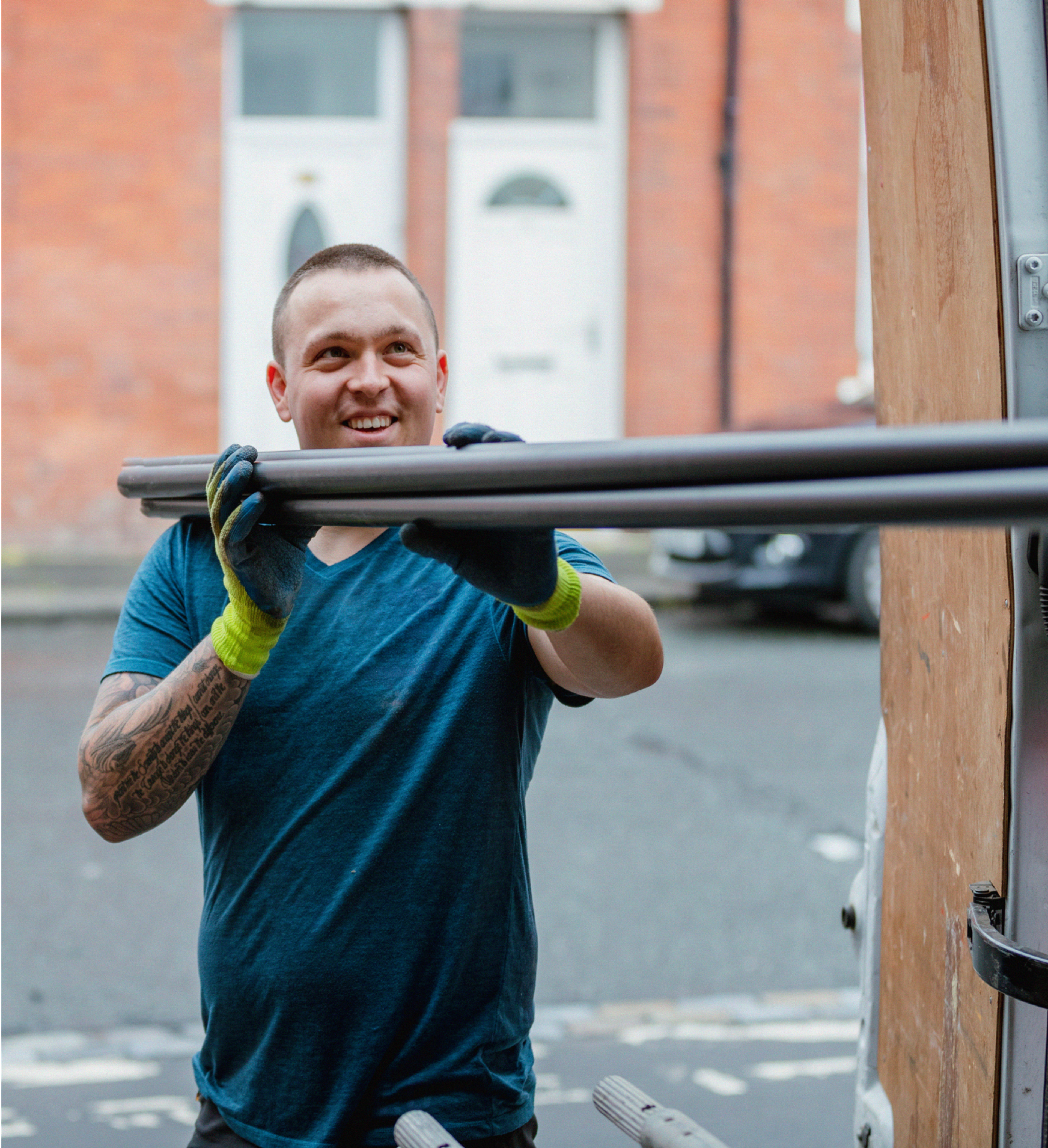 Tradesman loading  tools into his van