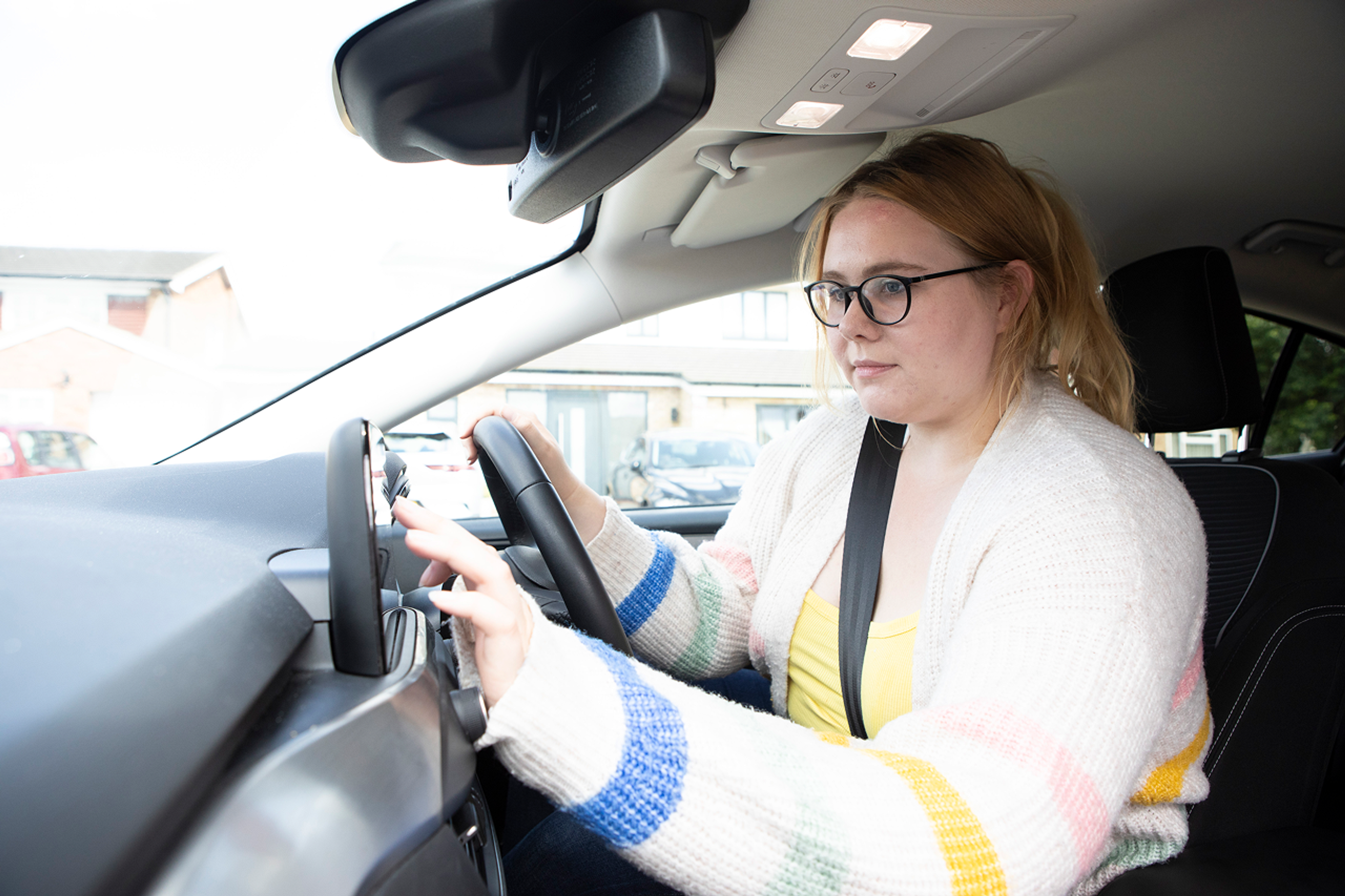 Women in parked car tapping car screen