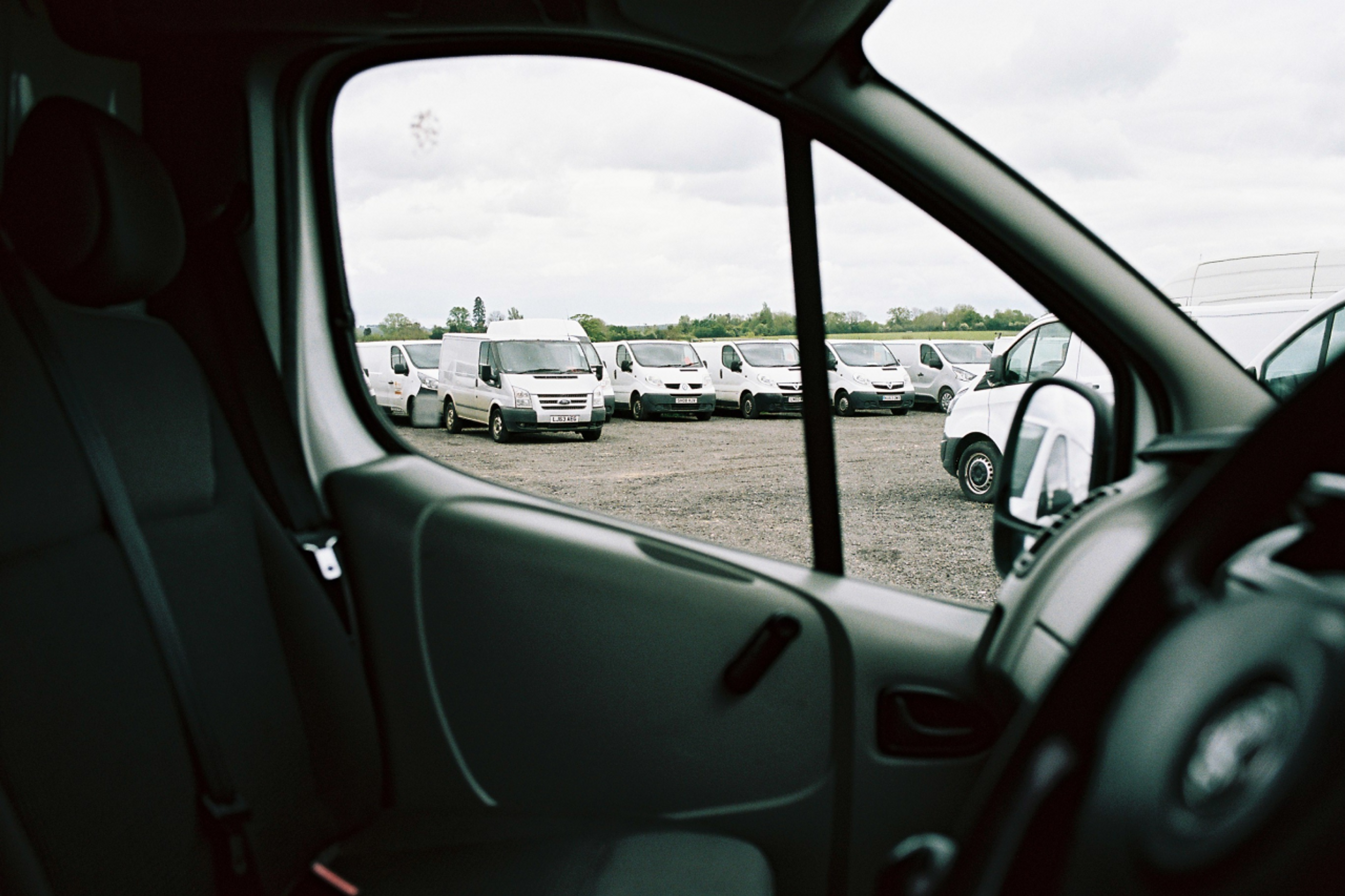 Fleet of parked white vans