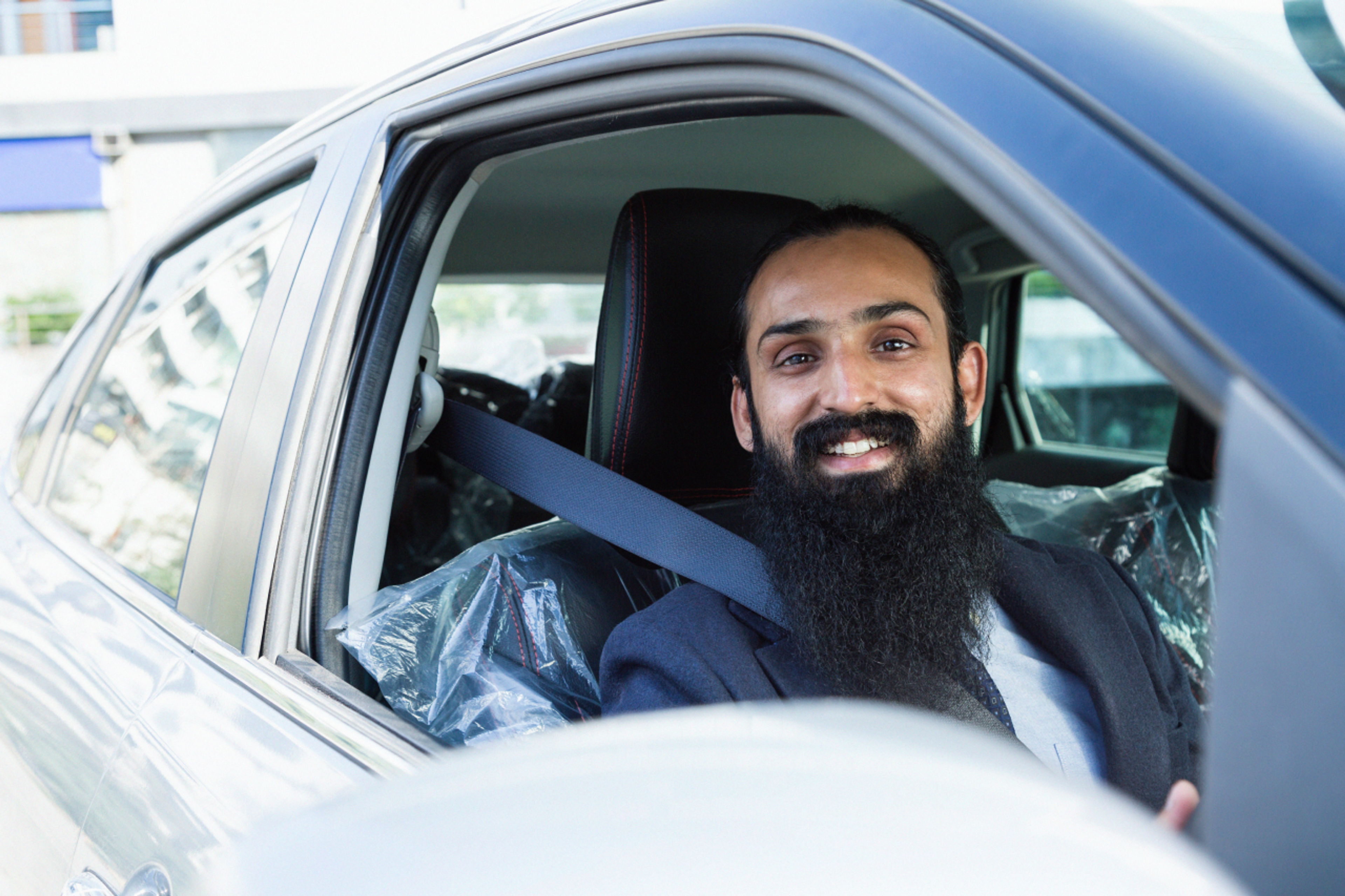 Taxi driver parked and smiling