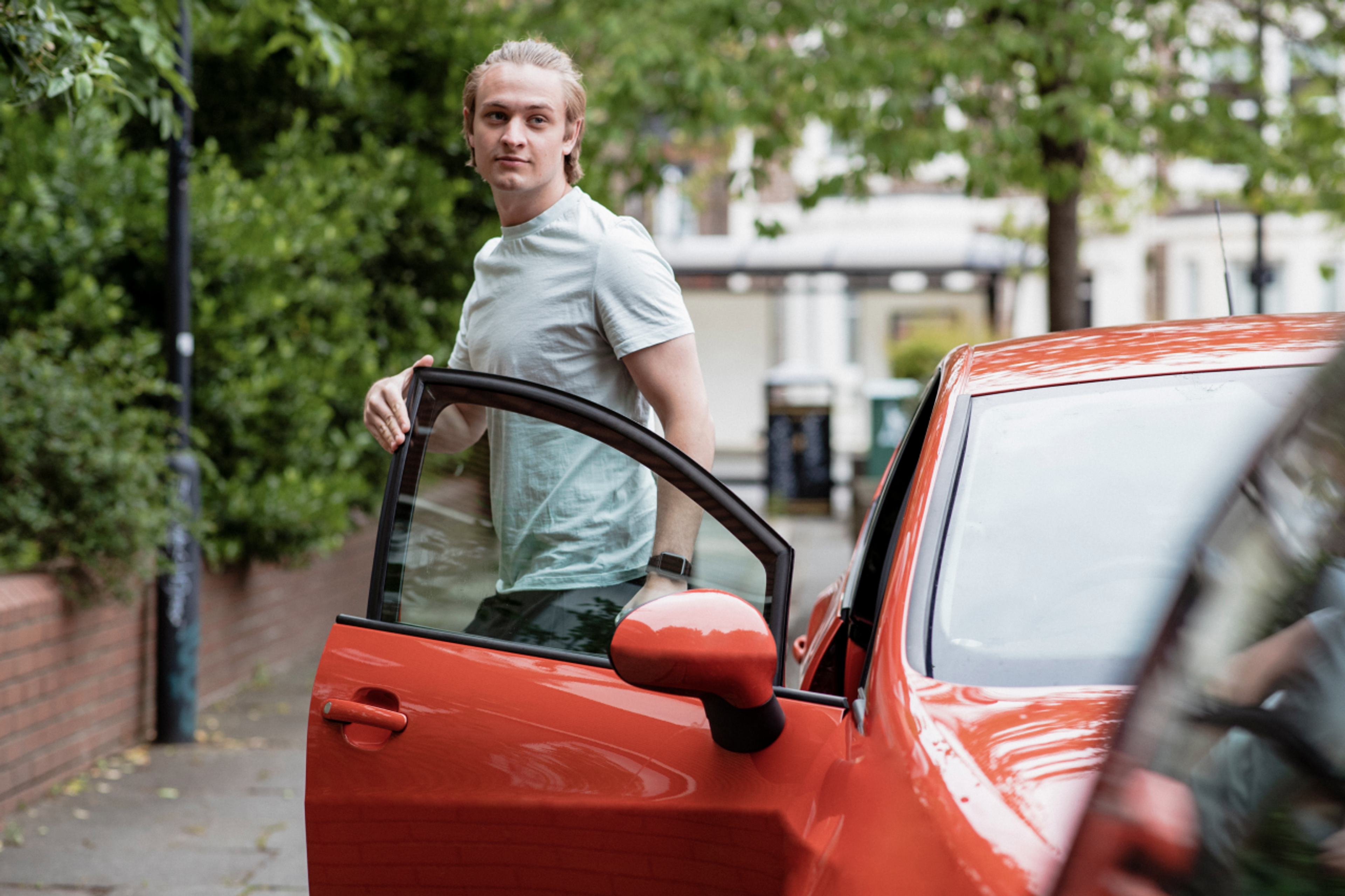 person stepping out of car