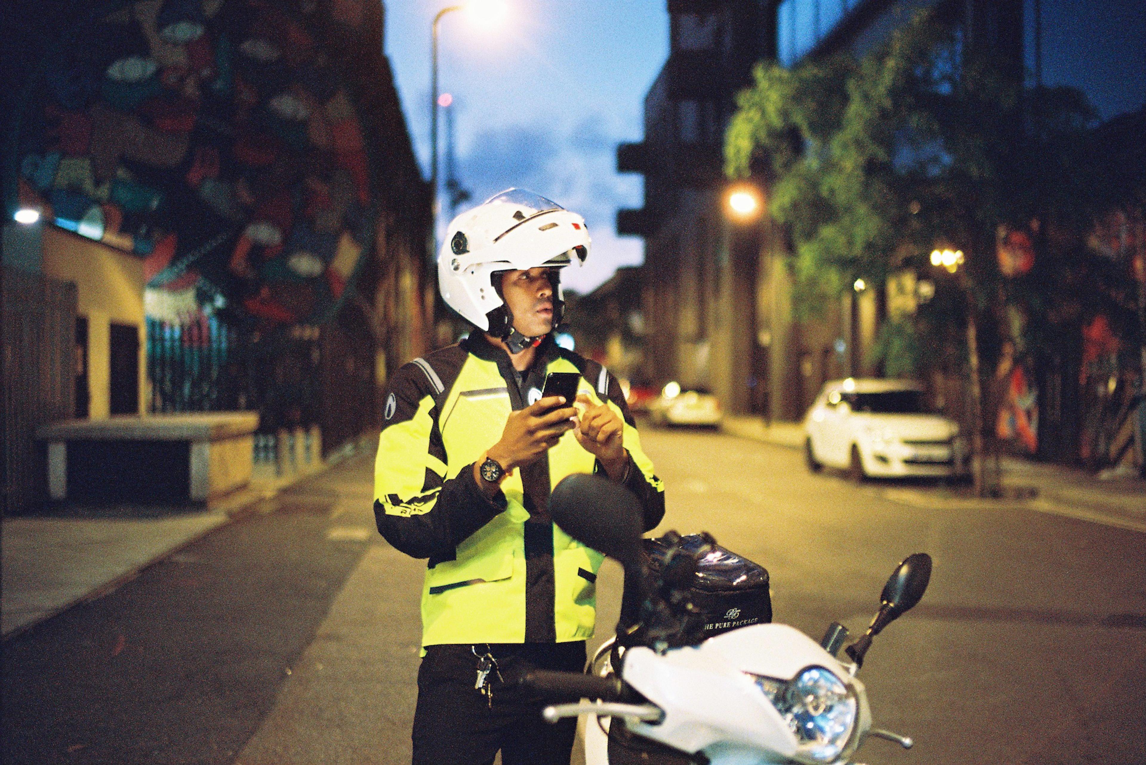 food delivery rider on his scooter with white helmet on