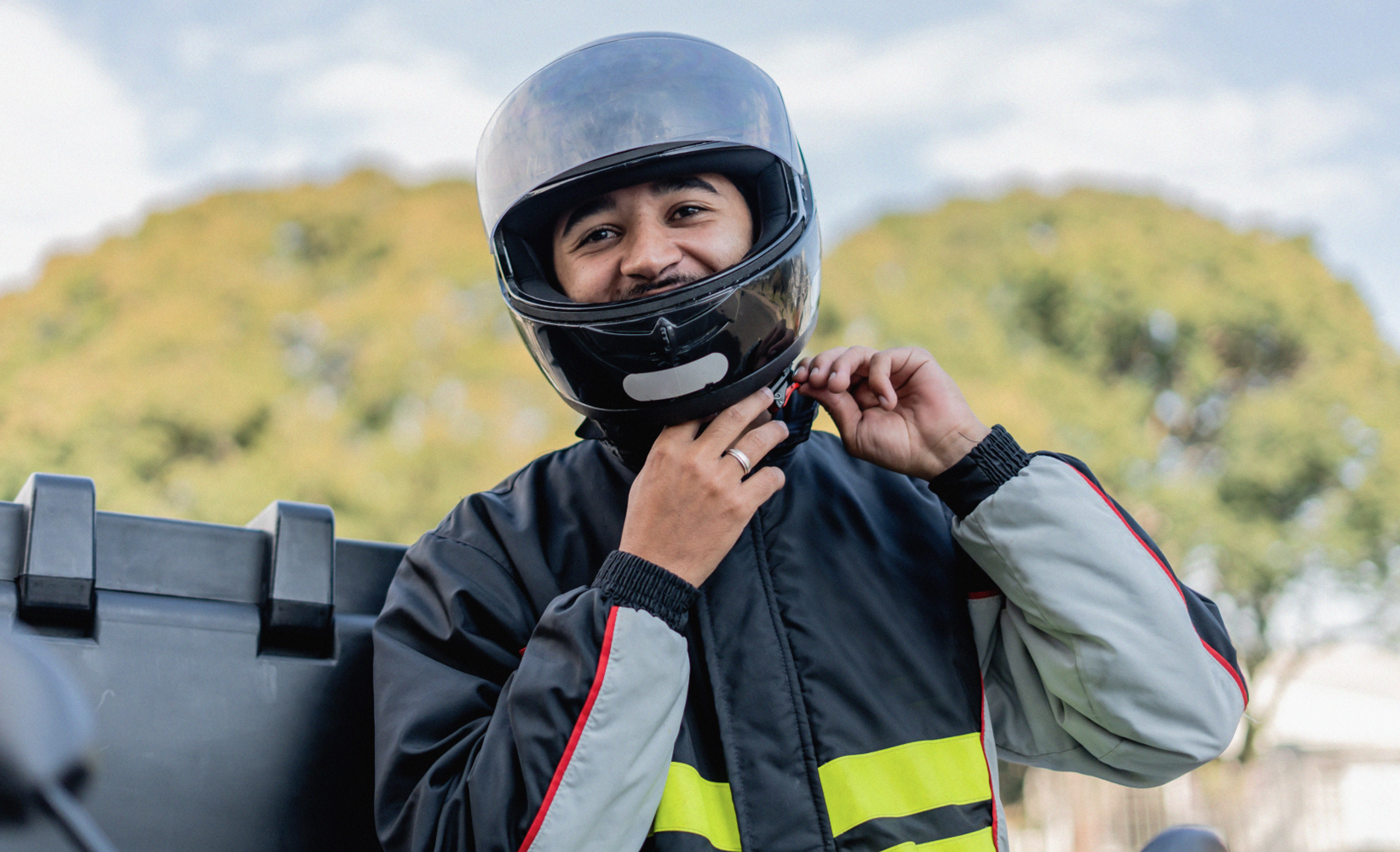 zego fast food scooter delivery driver putting on his helmet 