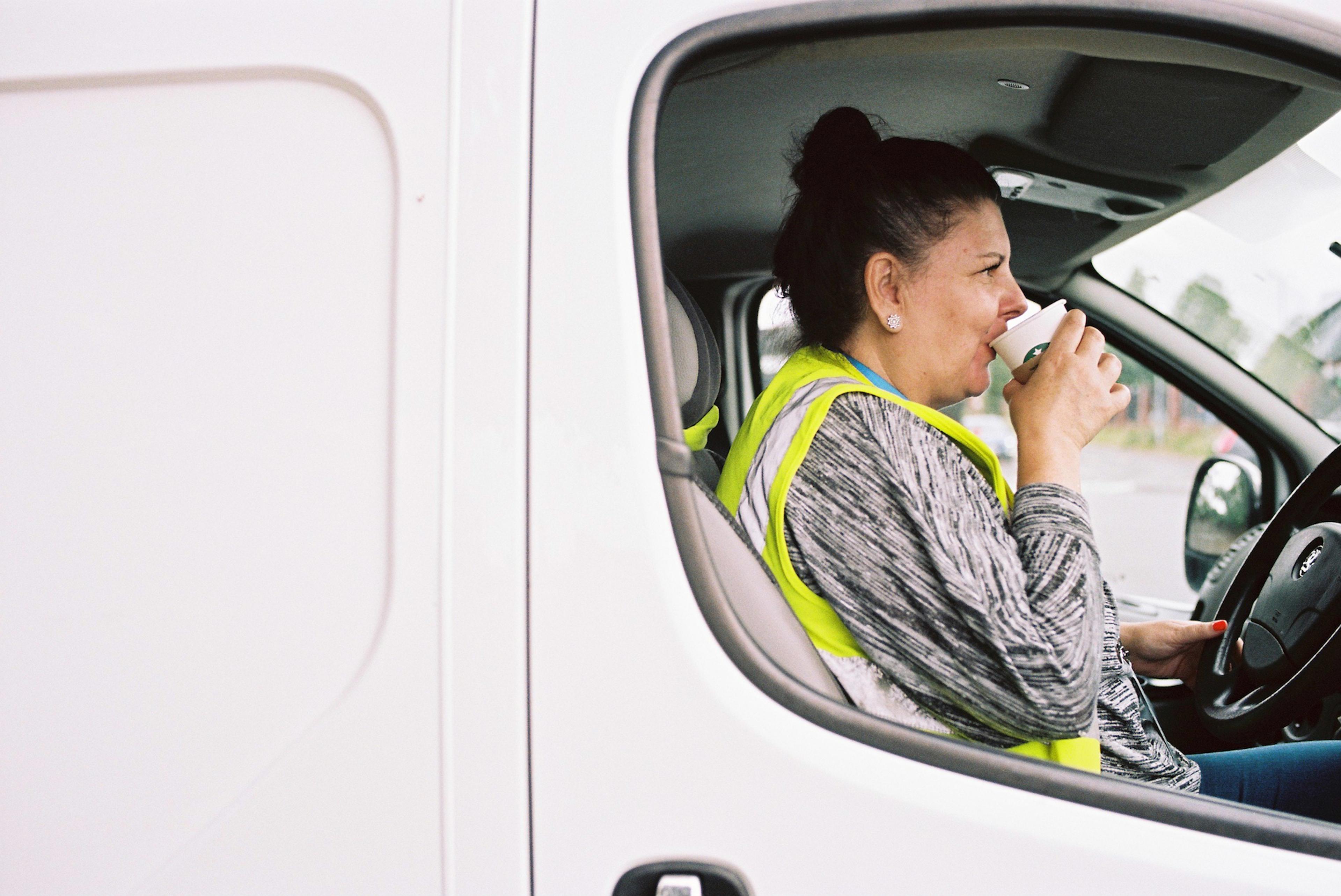 woman in her white work van 