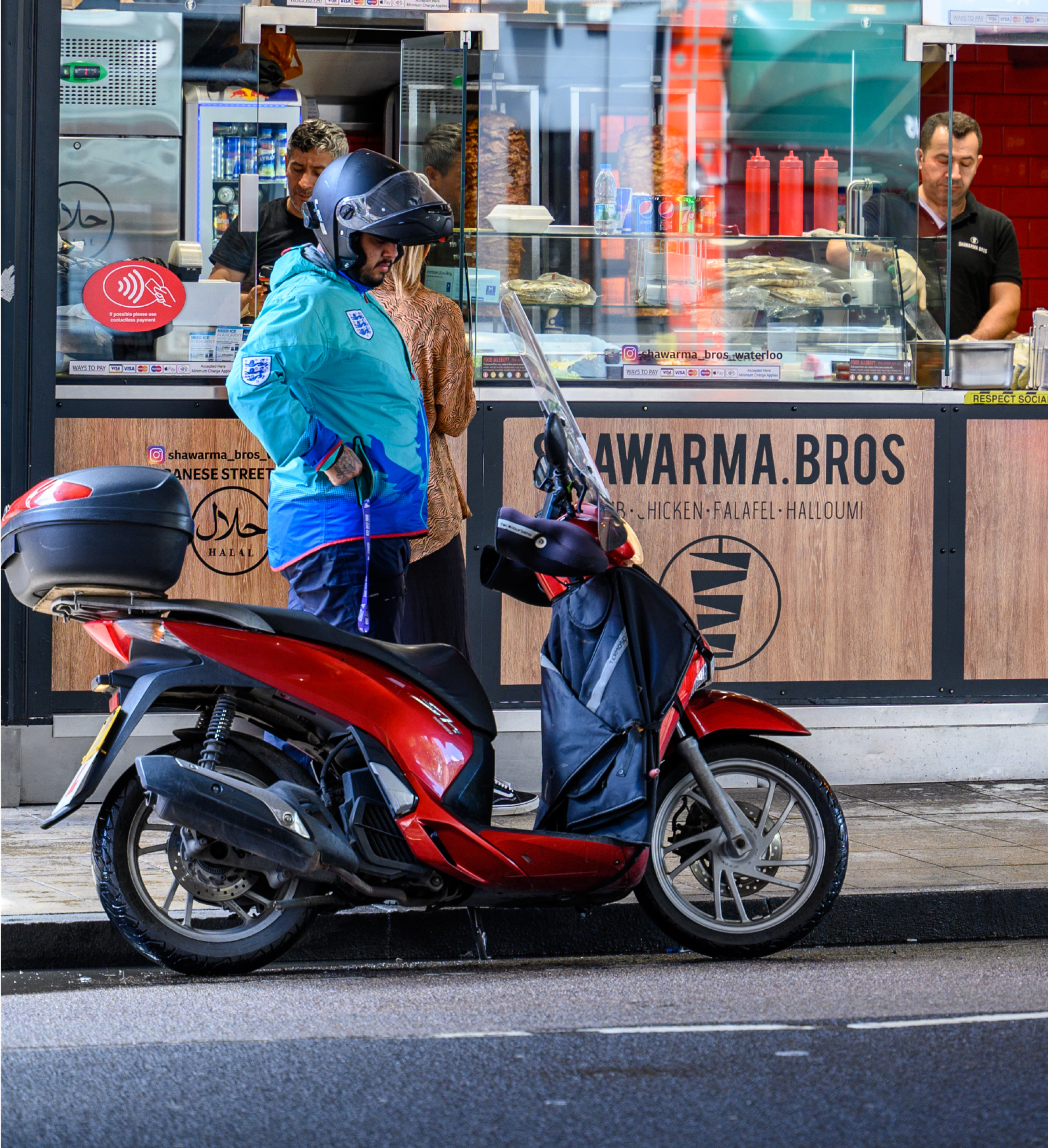 Zego scooter fast food delivery driver waiting for a pick up