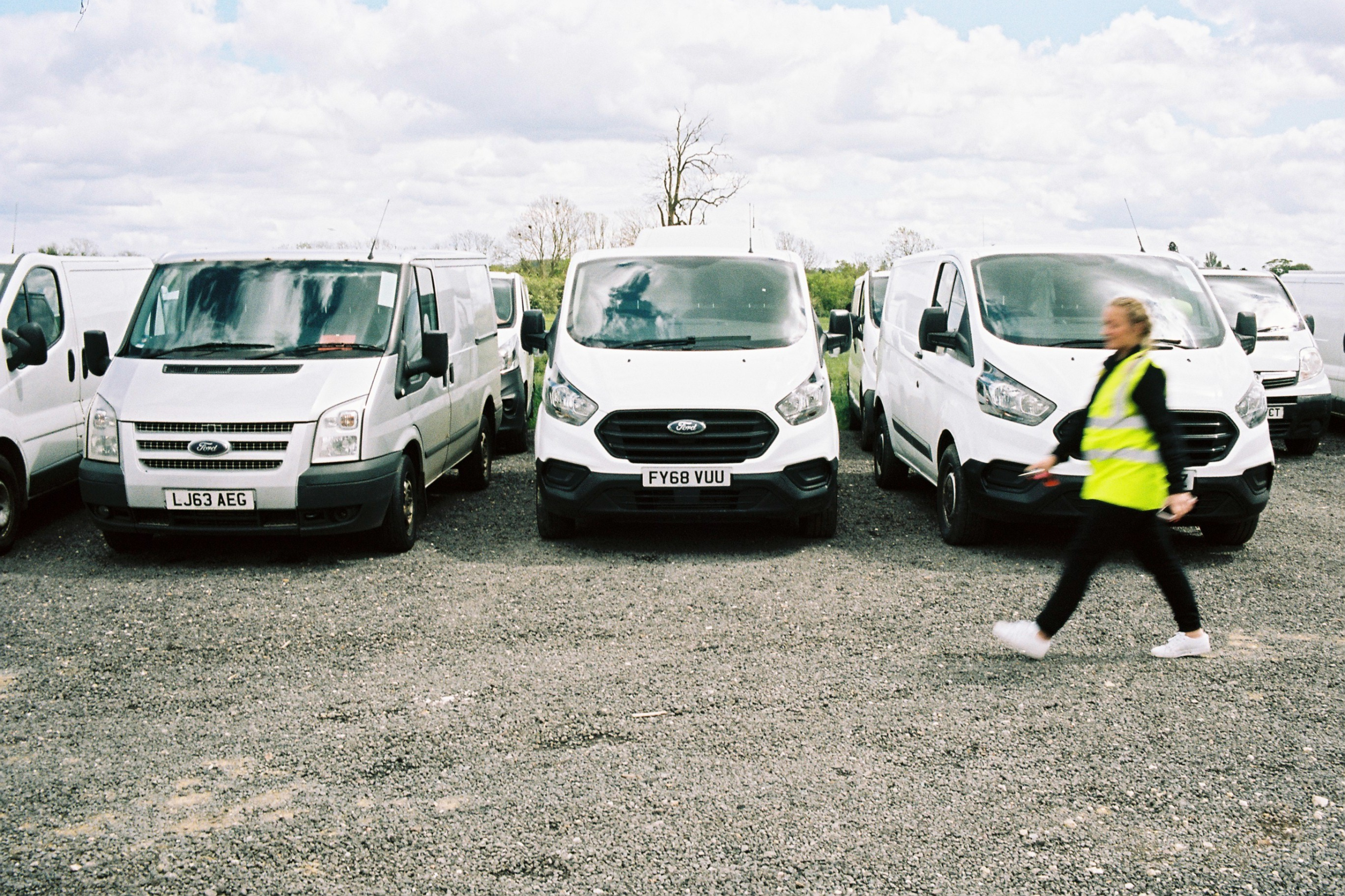 Van driver walking past parked vans