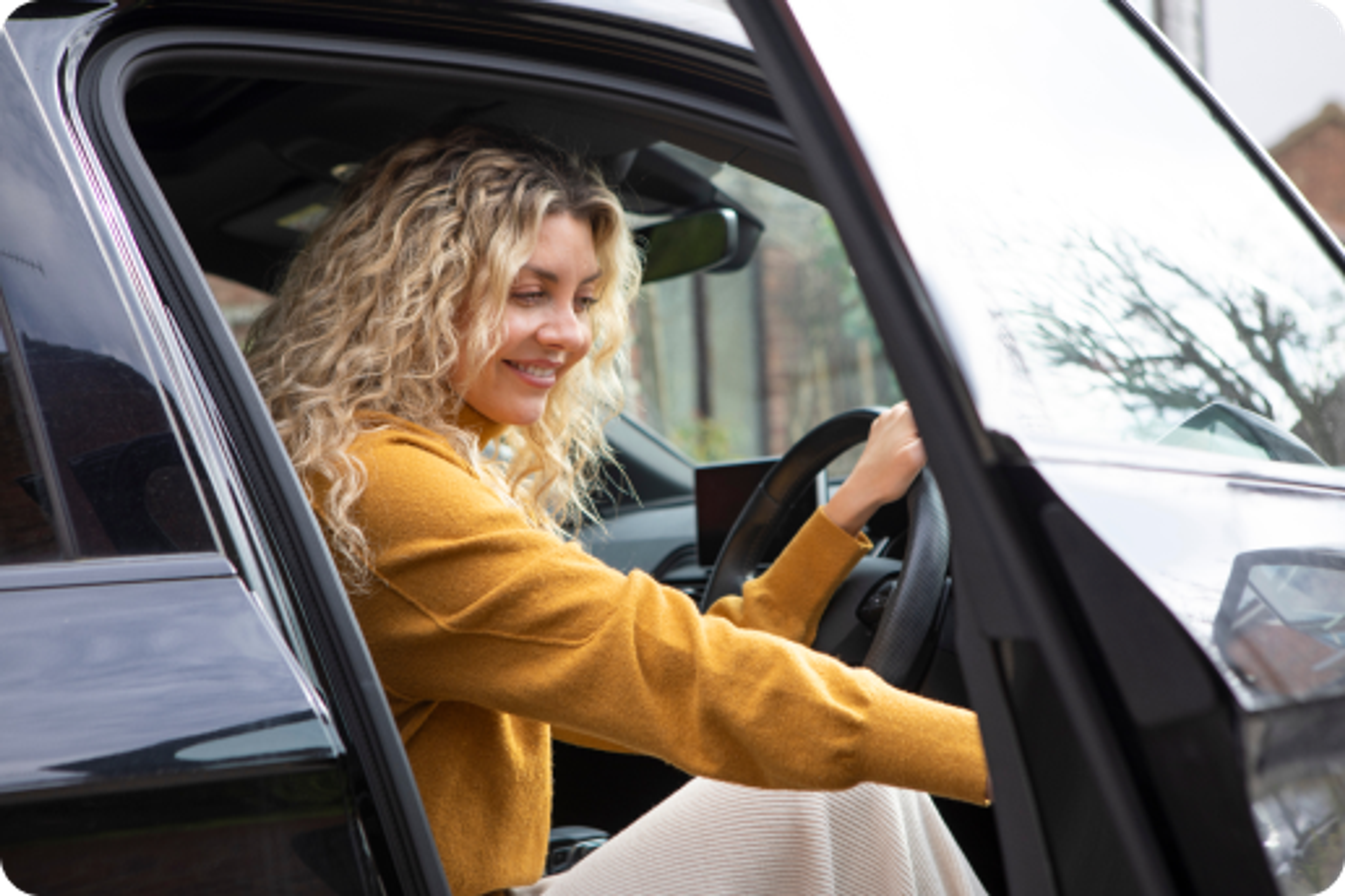 Zego new driver getting out of her zego insured car