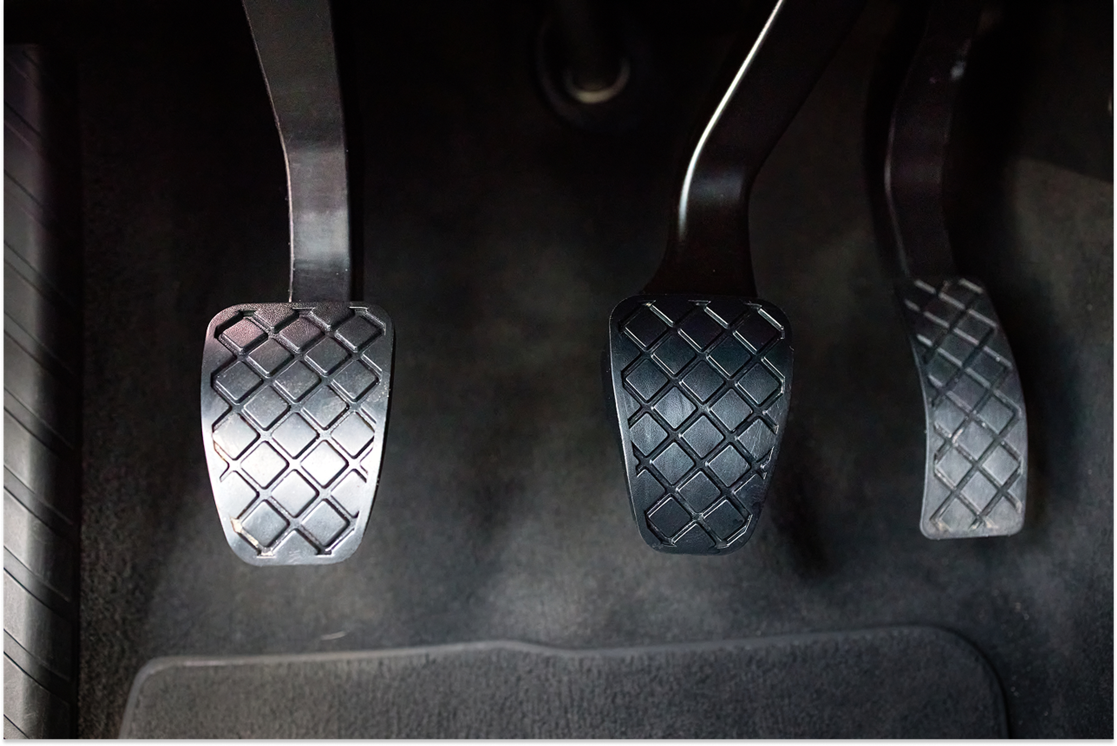 clutch, accelerator and brake pedals in a car