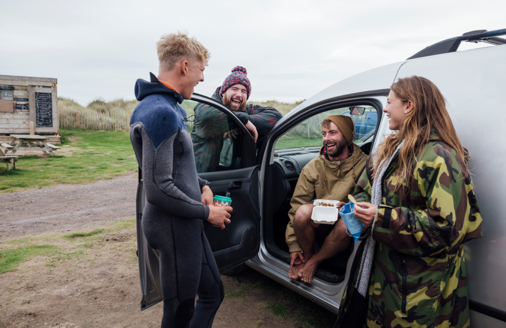 friends enjoying themself smiling near a white van for personal use.