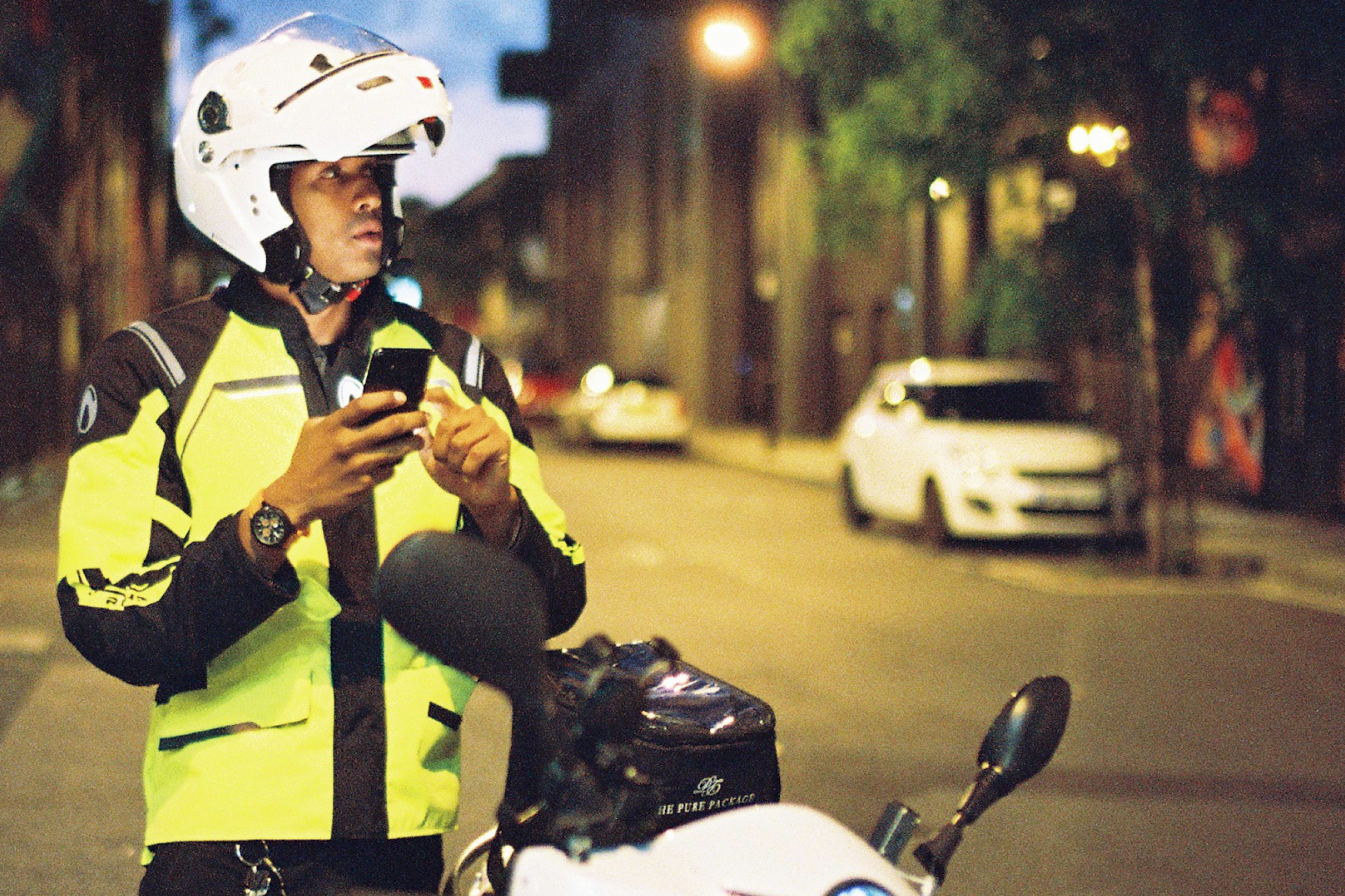 Food delivery driver checking address on his phone