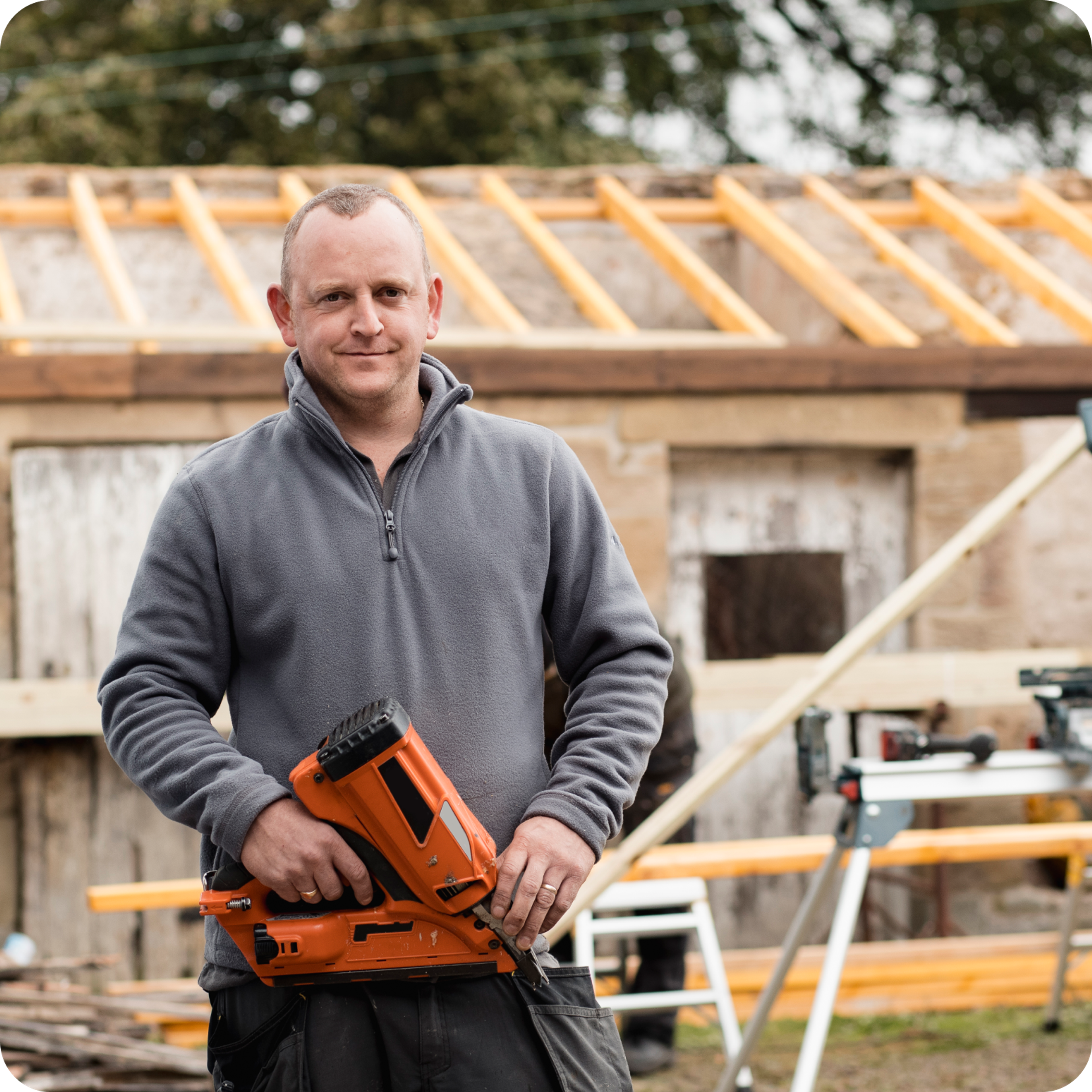 Tradesman holding a drill for wood.