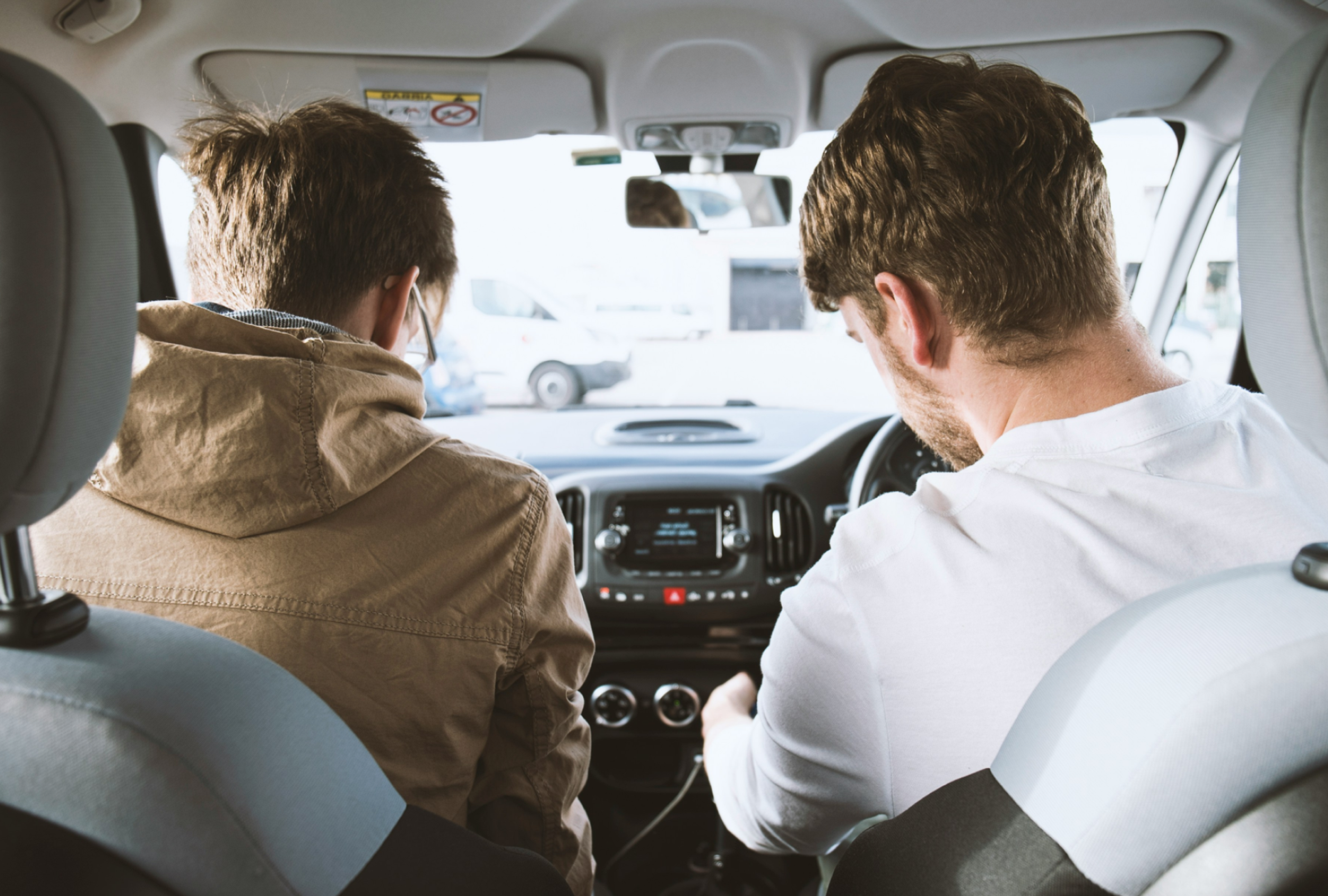 Two young men in a parked car