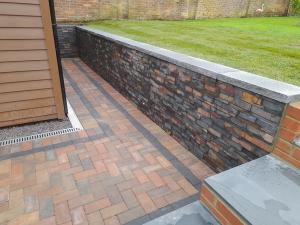 brick paving with slate retaining wall