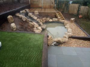 artificial grass with pond, paving and water feature