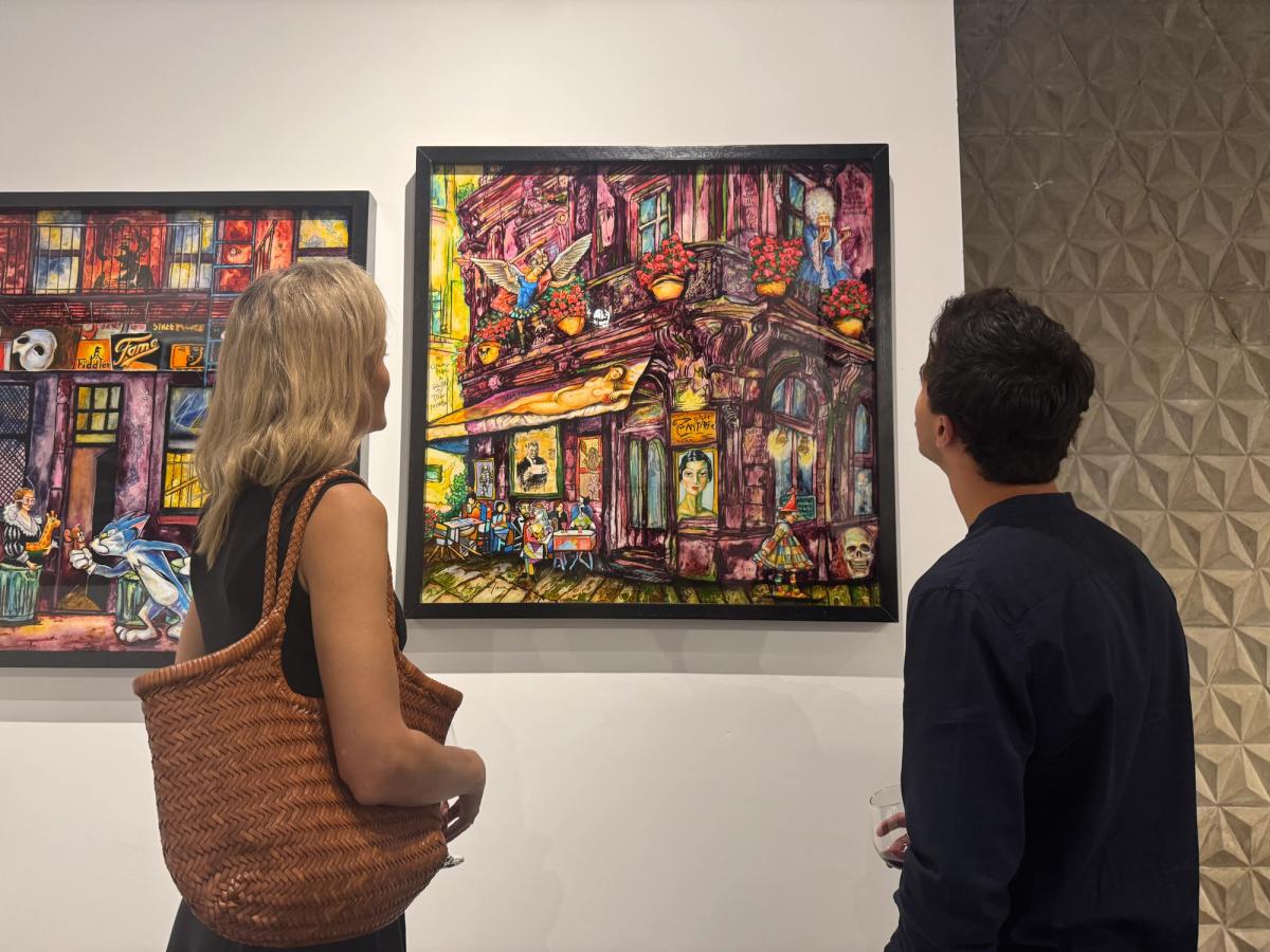 Clients looking at painting by Karla de Lara at OZA International