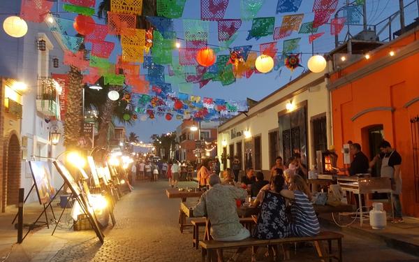 Colorful street in the San José del Cabo Gallery District during the weekly Art Walk with visitors and galleries