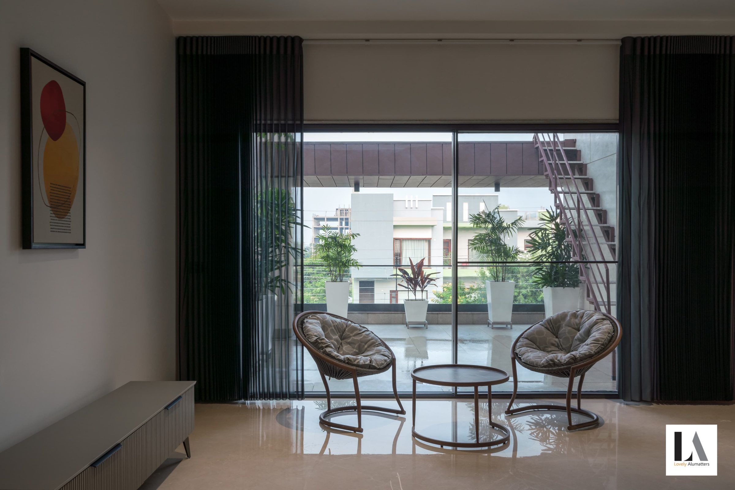 Sitting room opening through sliding glass doors to a balcony