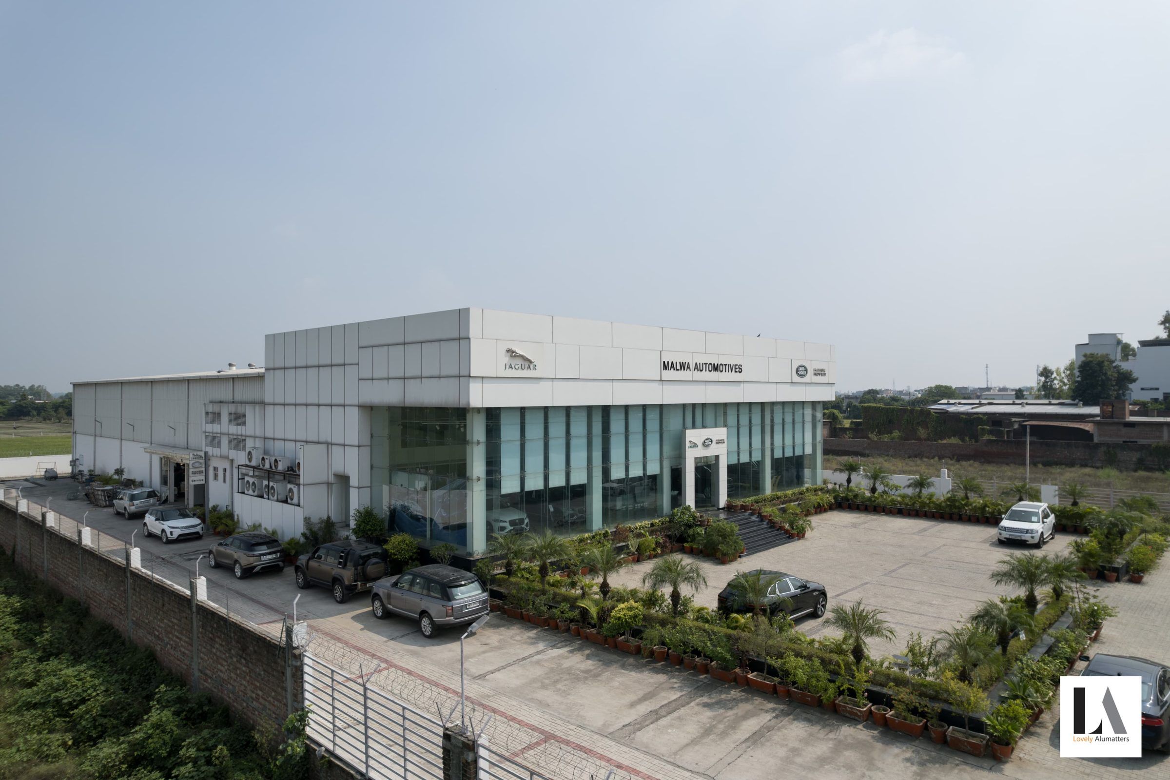 Aerial view of a showroom with a glazed frontage and landscaped forecourt