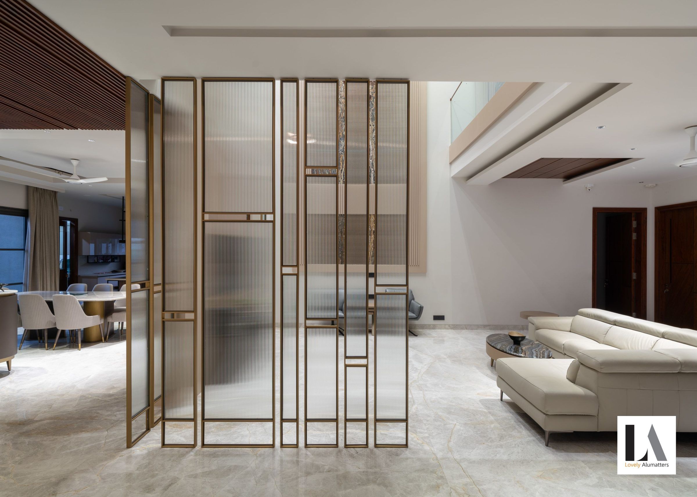 Double-height living area with a bronze glass screen and tall windows