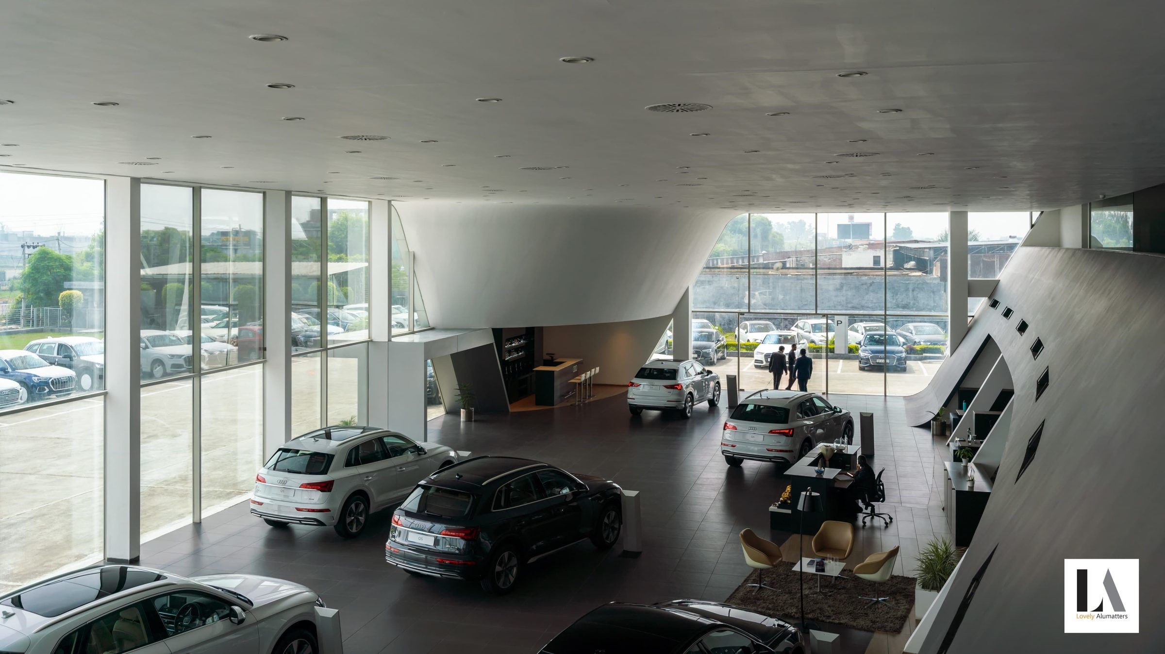 Showroom display floor wrapped by a full-height glazed façade