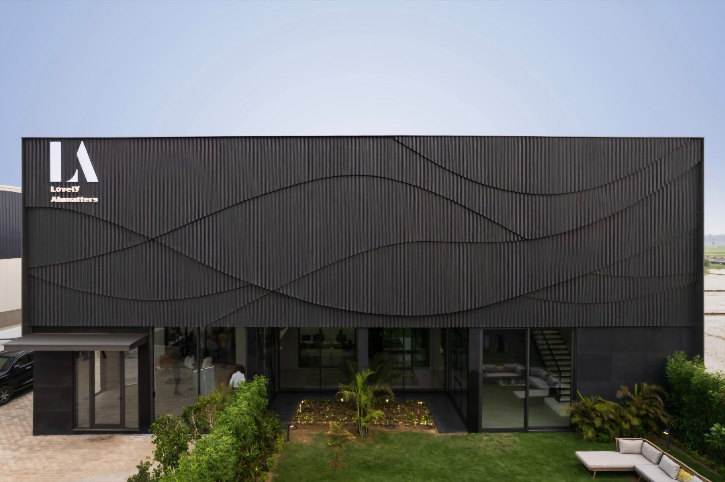Front elevation of the facility with glazed openings onto a garden