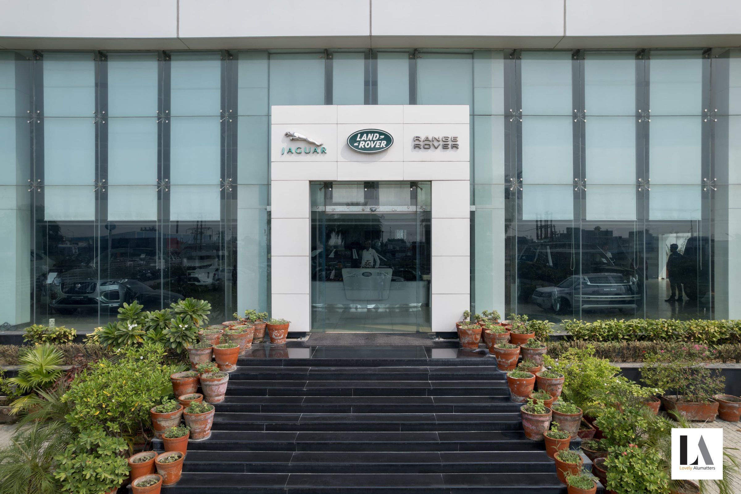 Glazed showroom entrance approached by wide stone steps