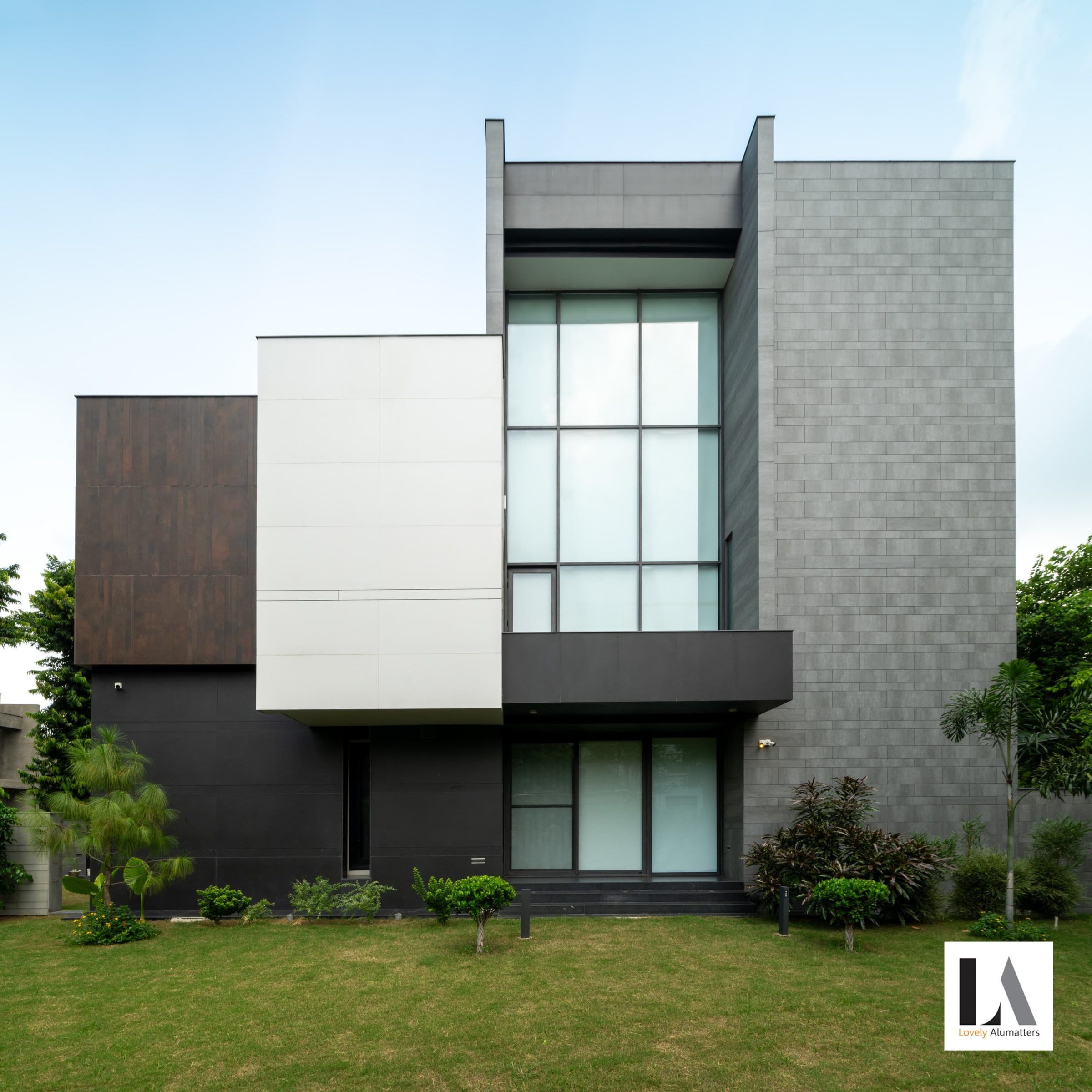 Three-storey residence in grey and white with tall gridded windows