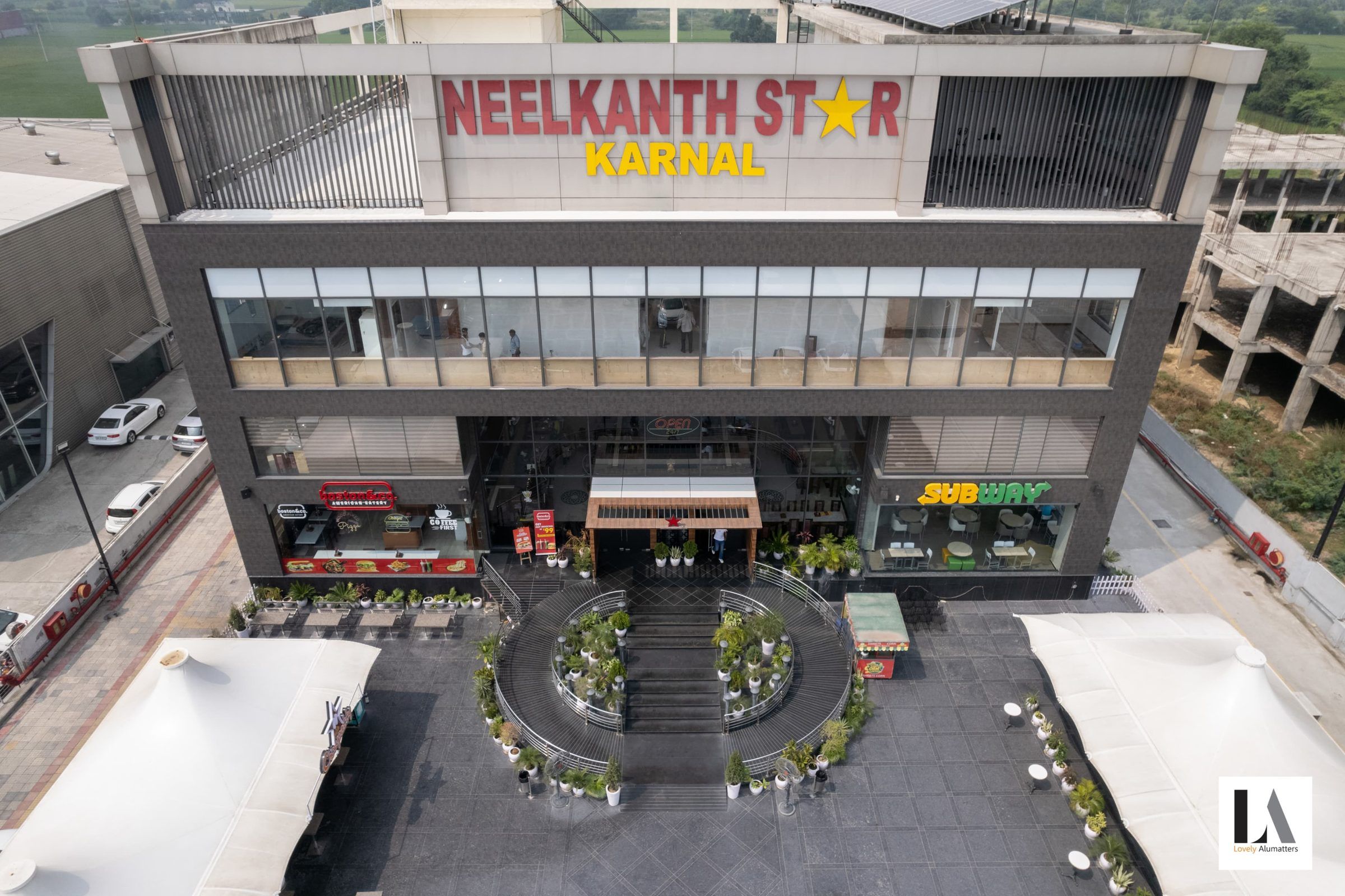 Elevated view of the glazed hospitality building and circular entrance court