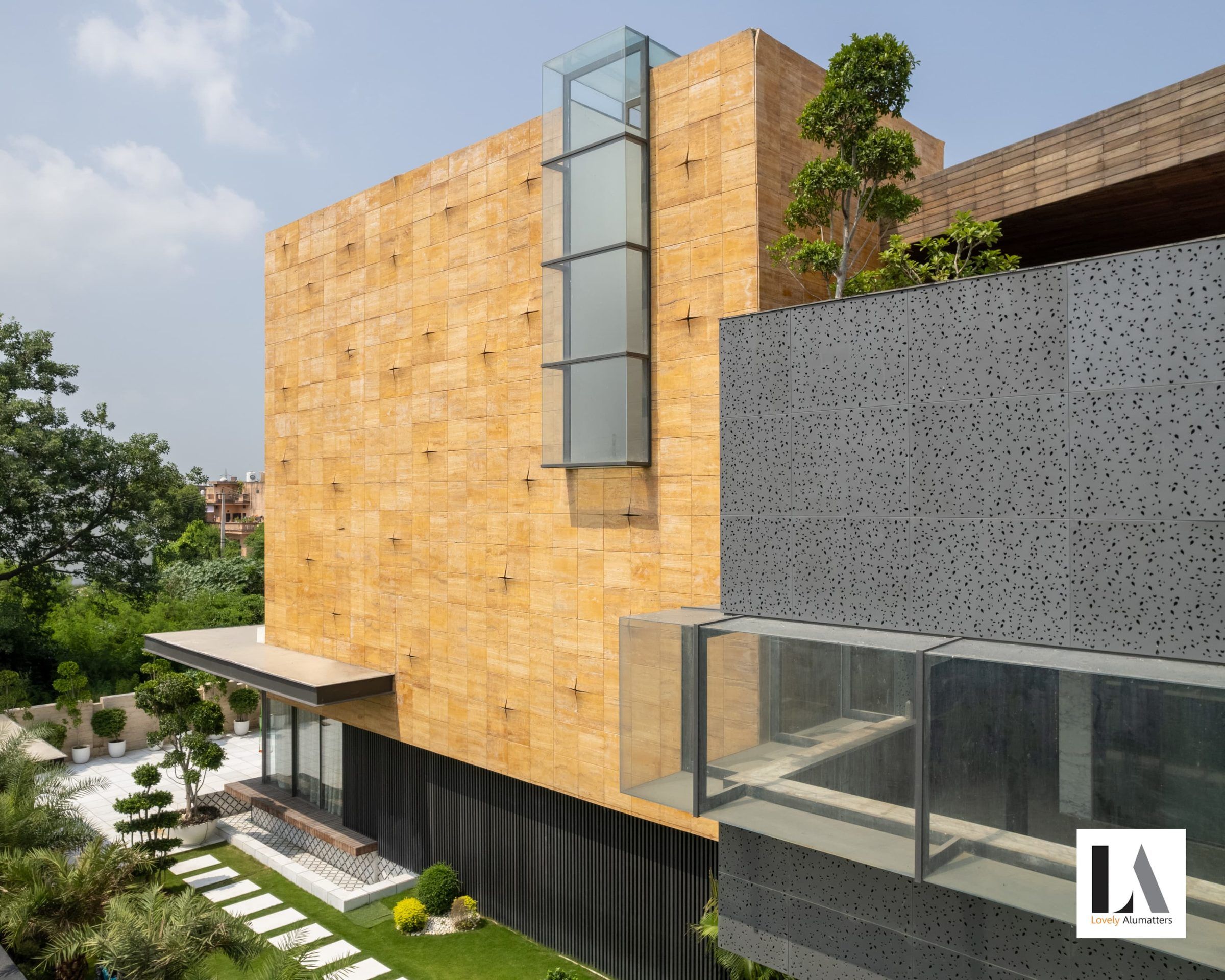 Stone façade with a slim vertical glazed slot and a glass balcony