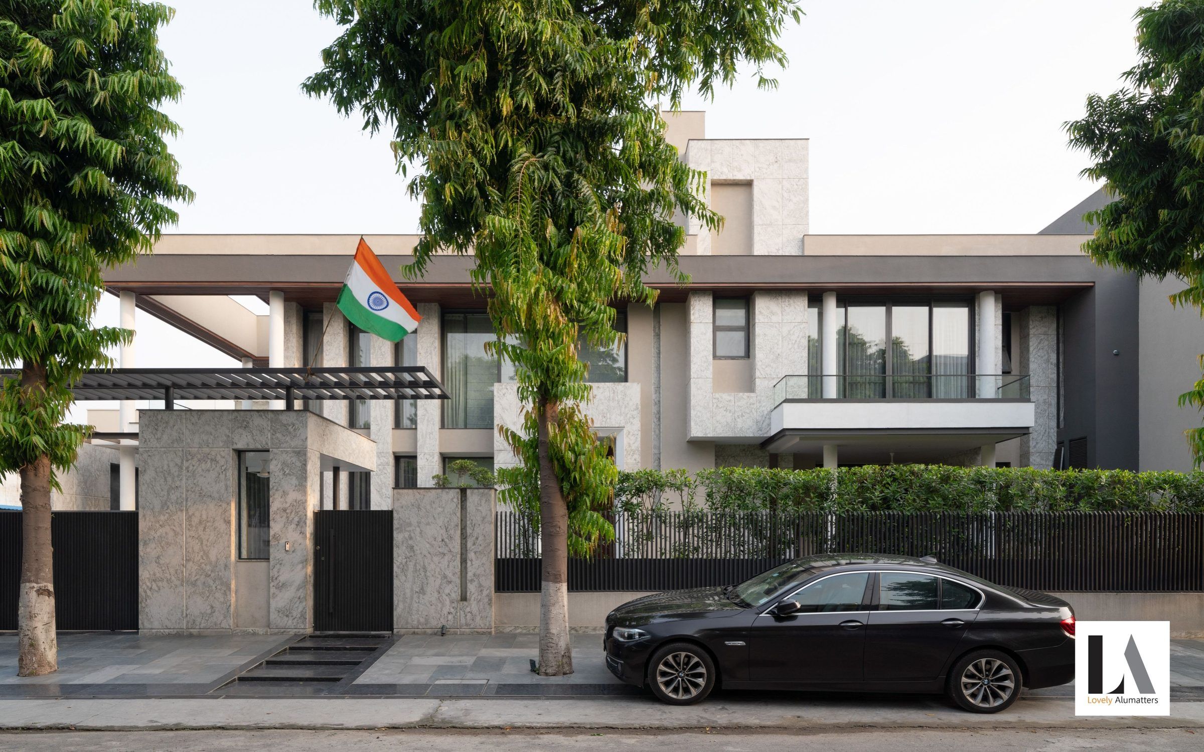 Villa street elevation with long horizontal windows behind the boundary wall