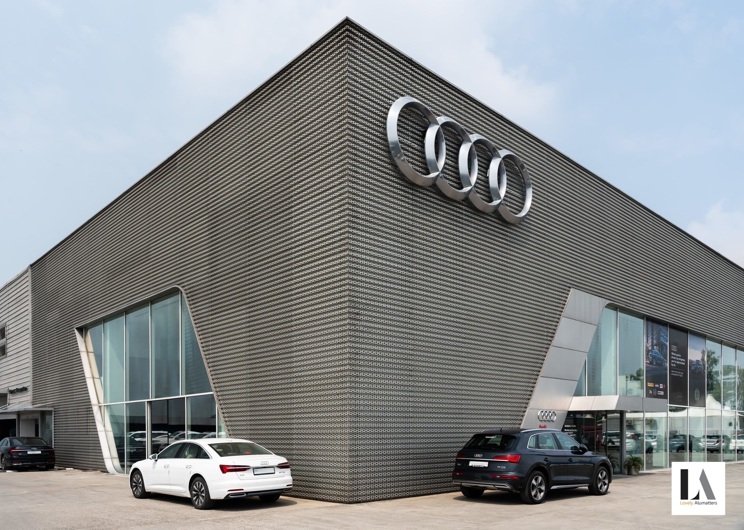 Angled showroom façade with a tall glazed entrance