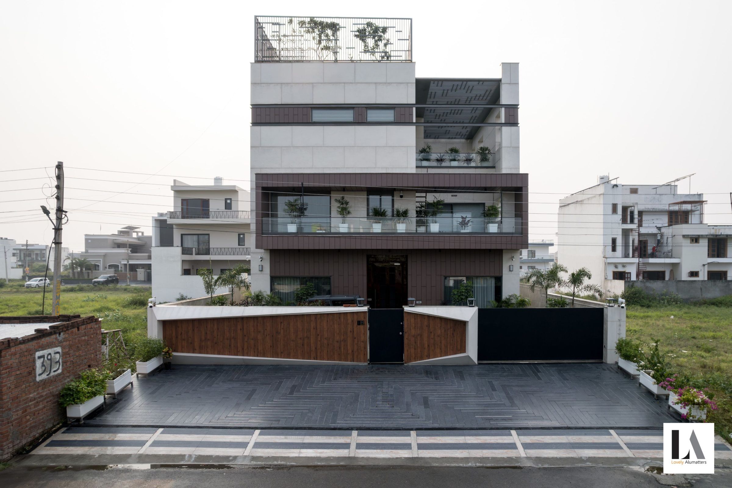 Three-storey residence with terraces and timber-clad boundary gates