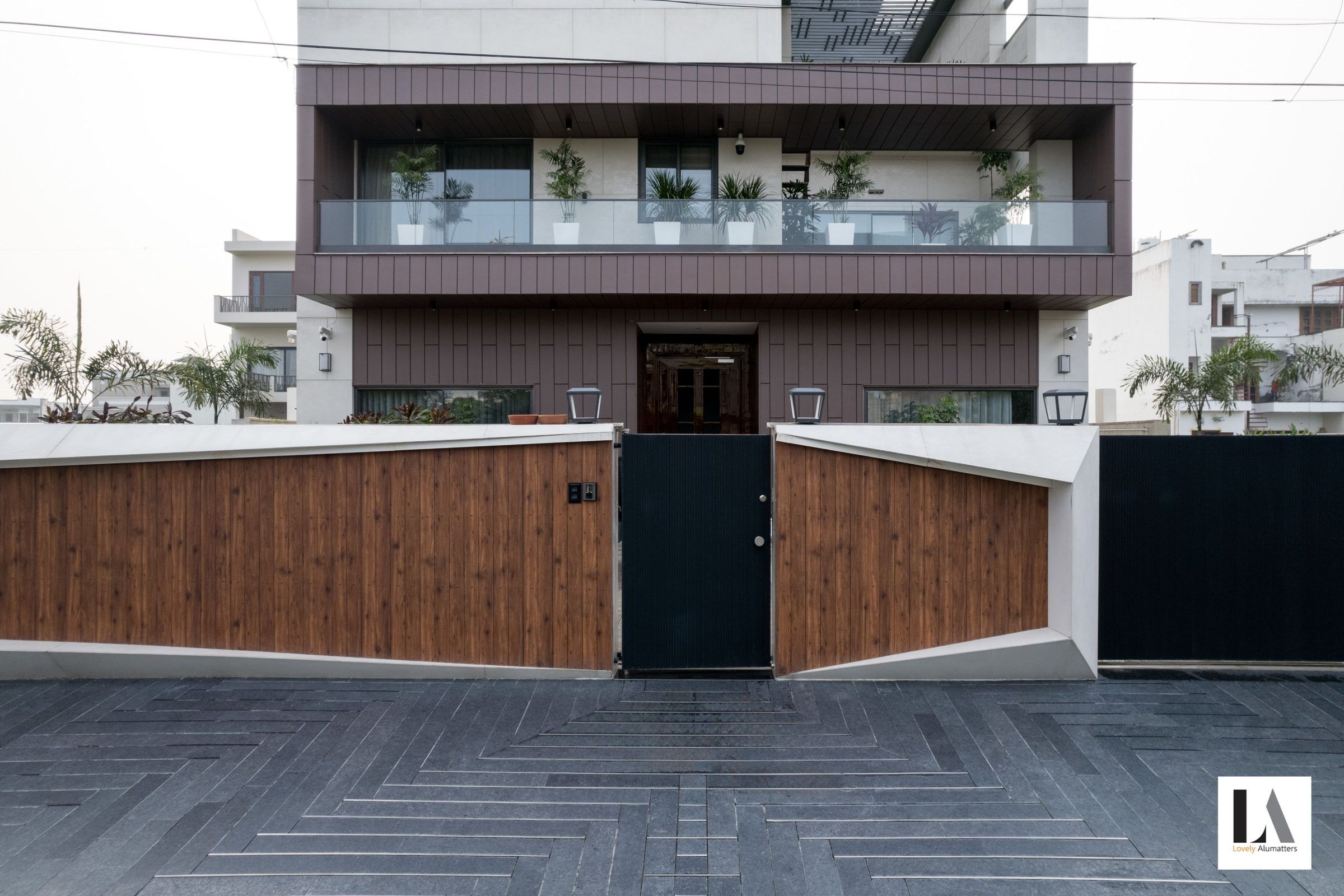 Residence frontage with glazed terraces above a timber gate