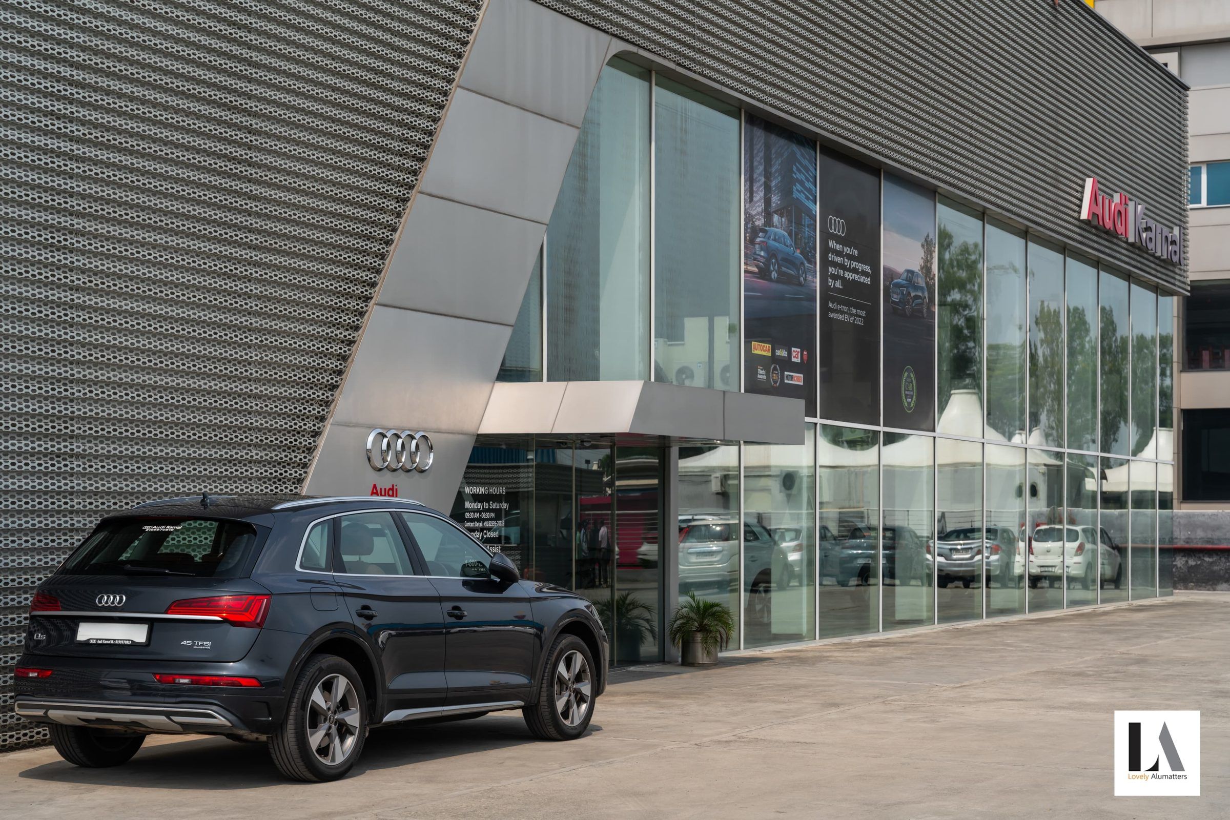 Showroom entrance with full-height glazing and a slanted canopy