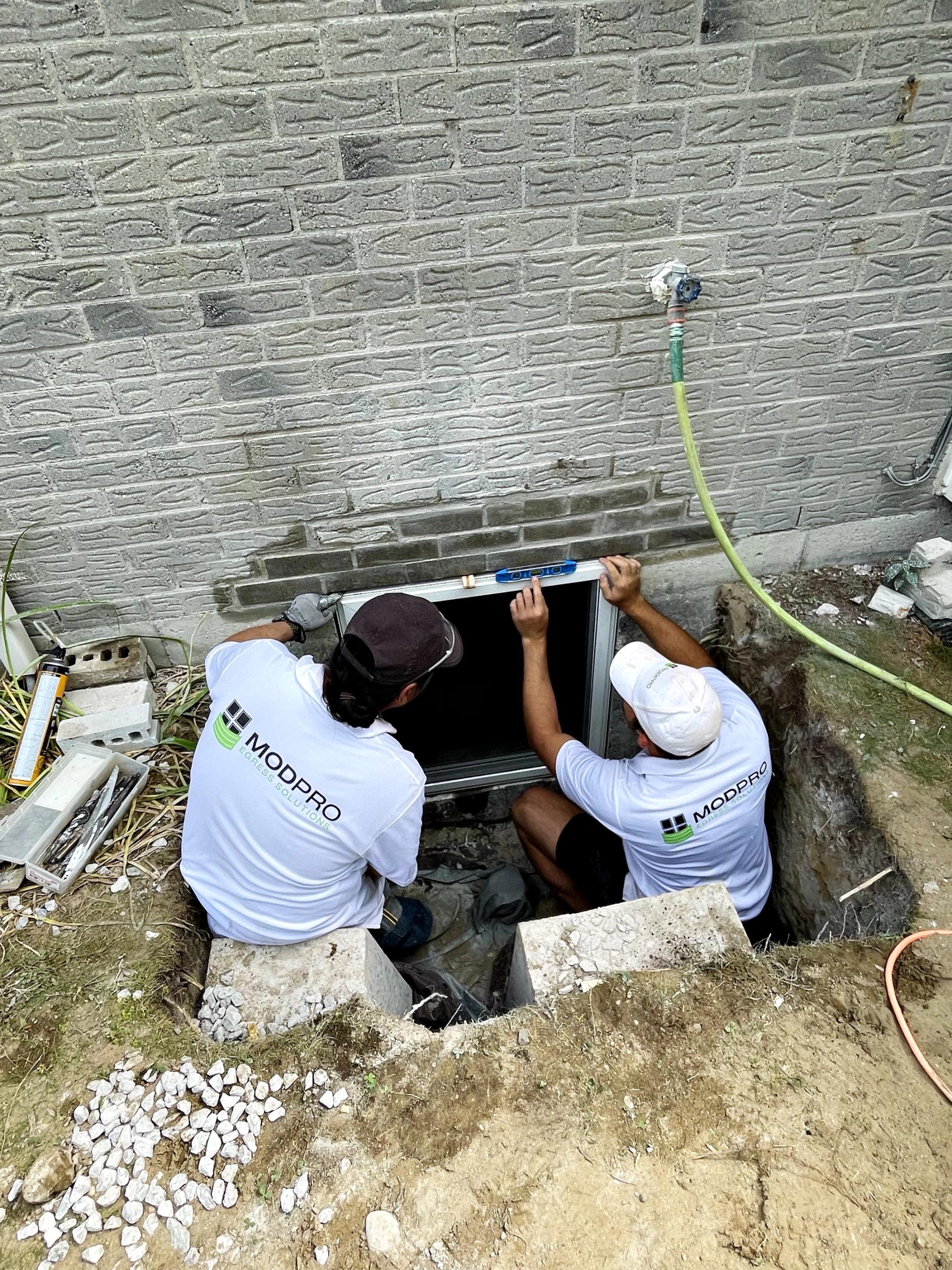 Modpro crew completing a basement window replacement in Pickering — Durham Region specialists