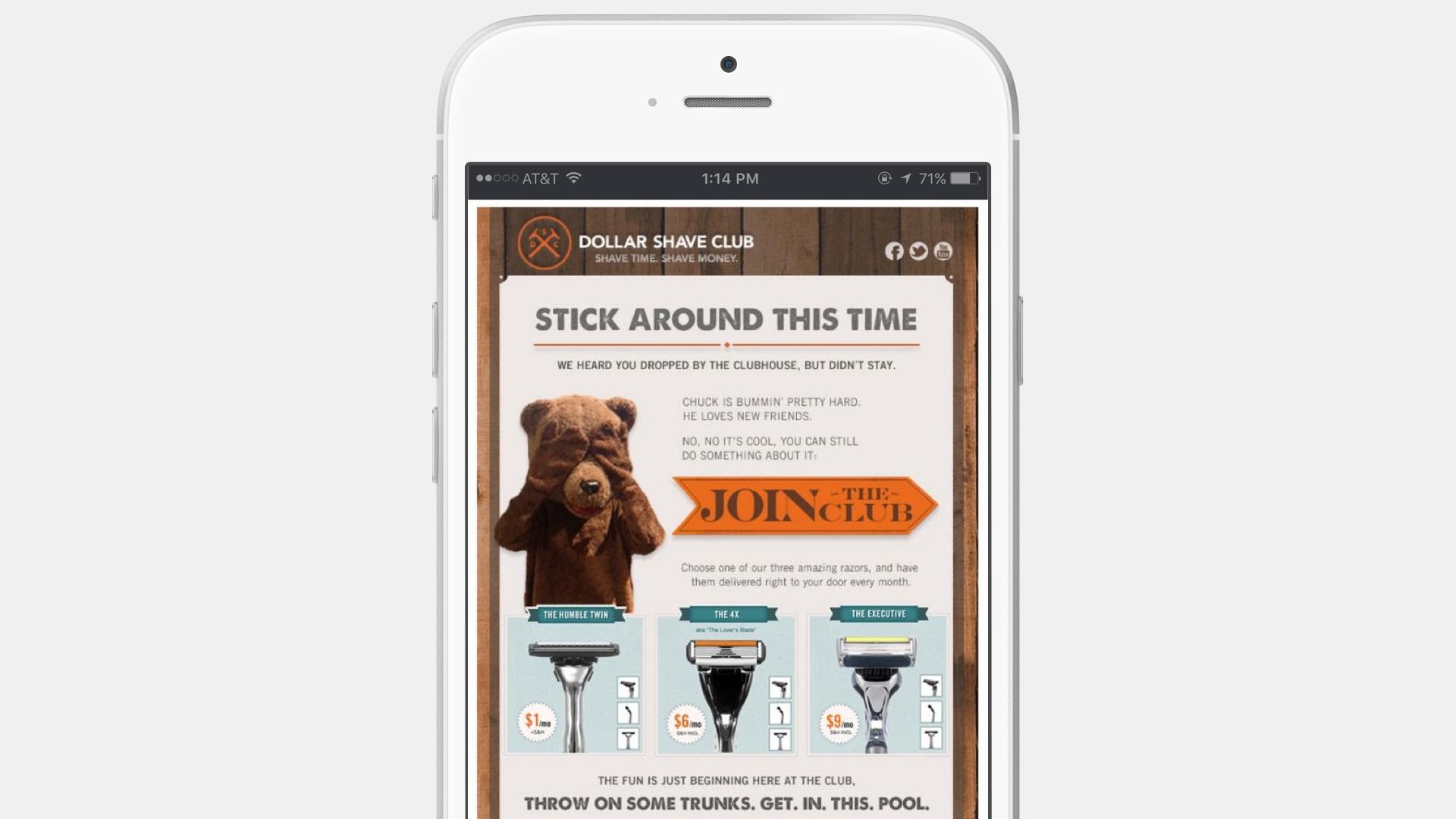 A smartphone displaying a Dollar Shave Club advertisement featuring a bear mascot and options to join the club. The text encourages users to stick around and check out their products.