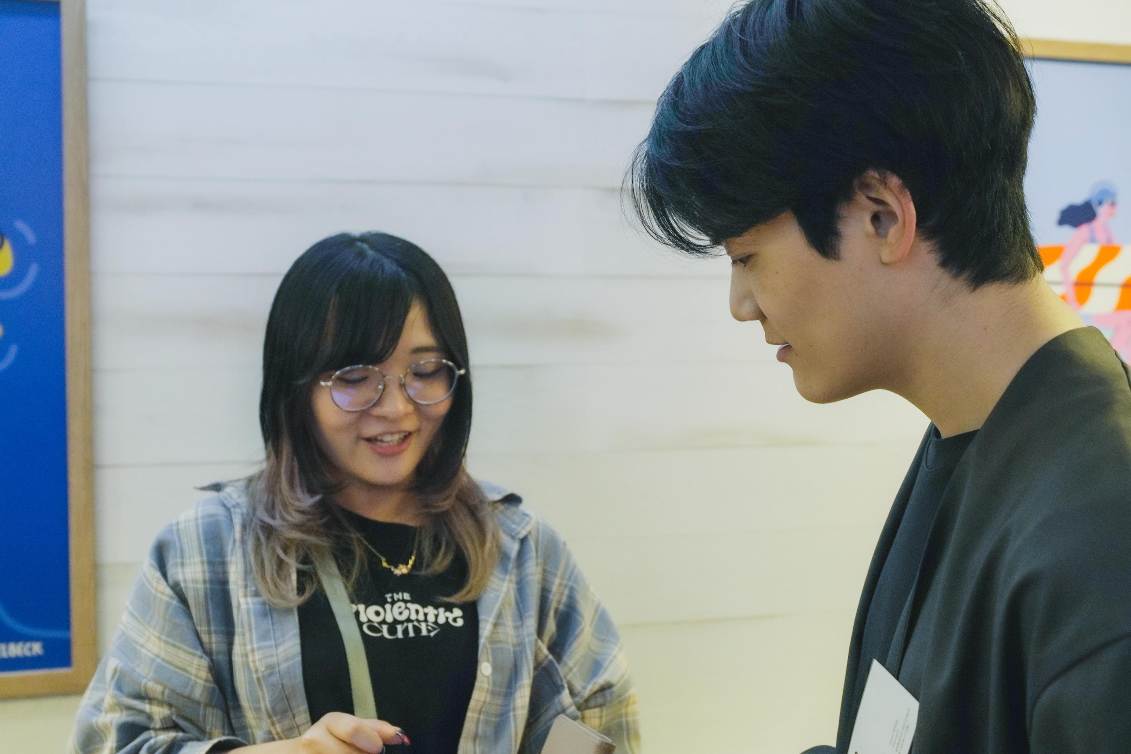 a man and a woman are talking to each other in a room .