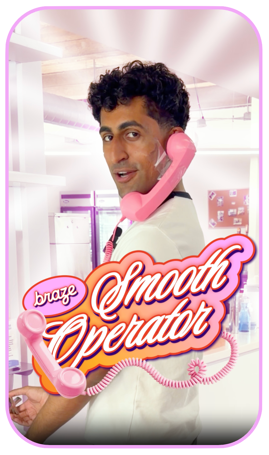 A man with shaving foam on his cheek holds a pink retro telephone to his ear, with "braze Smooth Operator" text in the foreground.
